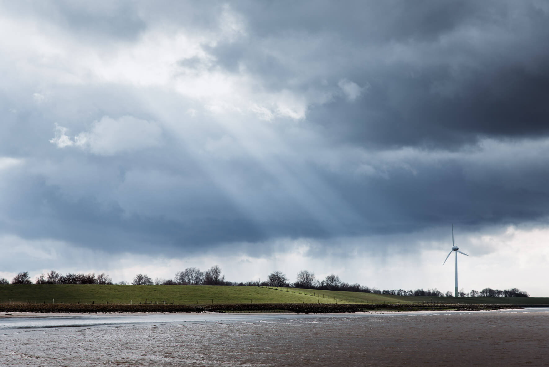Sun breaking through clouds over North Sea Coast
