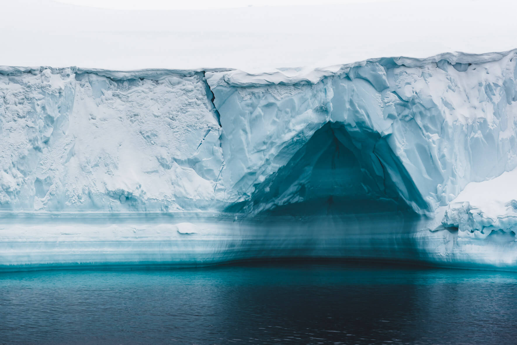 Ice cave in iceberg in Arctic waters of Greenland
