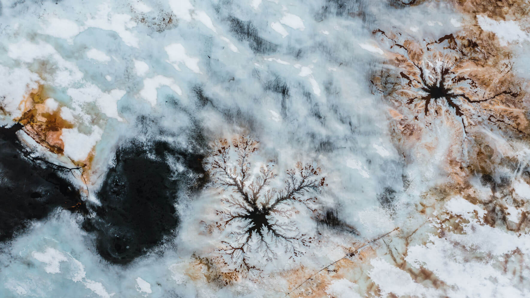 Abstract patterns on a frozen lake in Norway from a drone's perspective