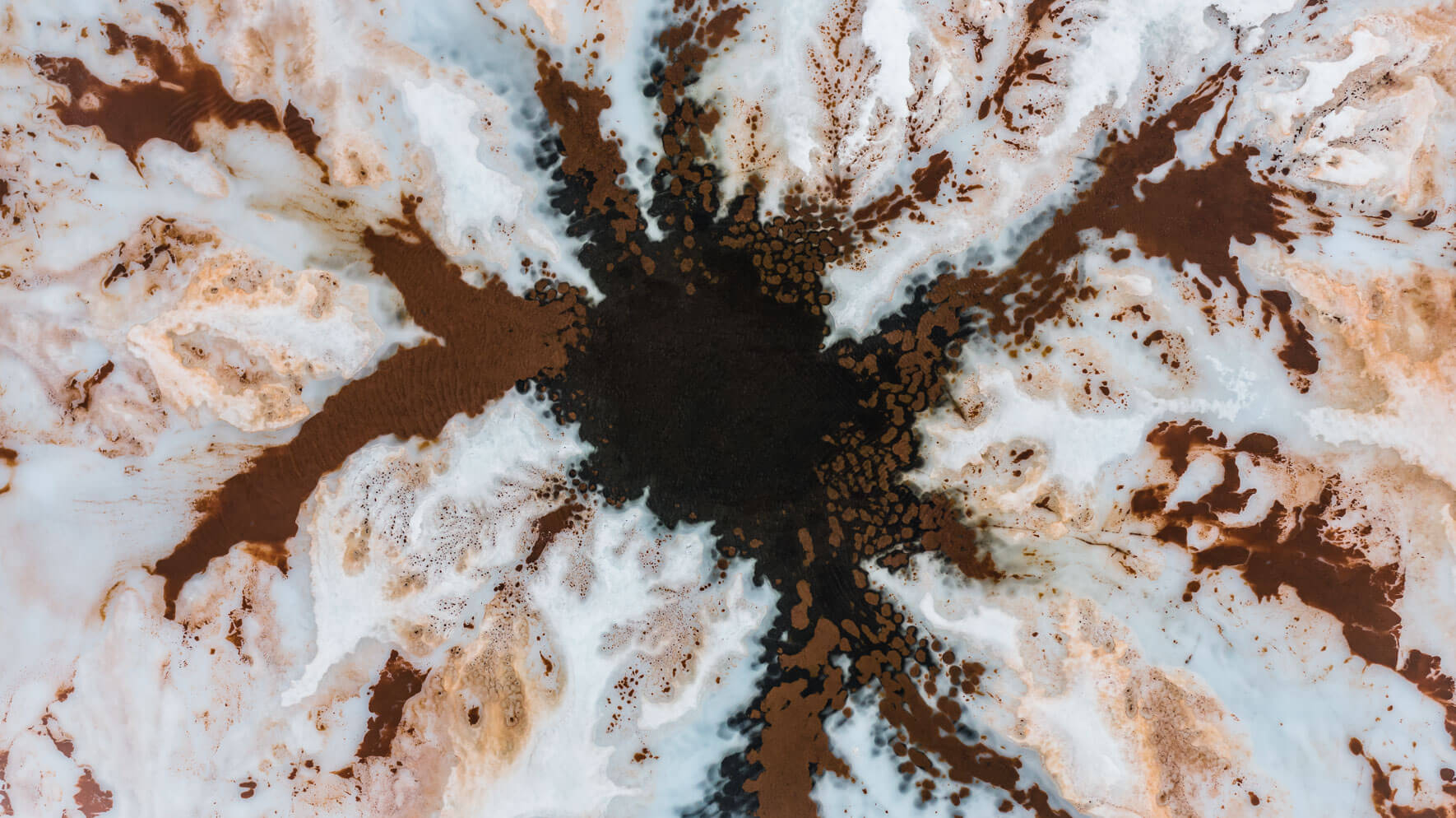 Abstract patterns on a frozen lake in Norway from above