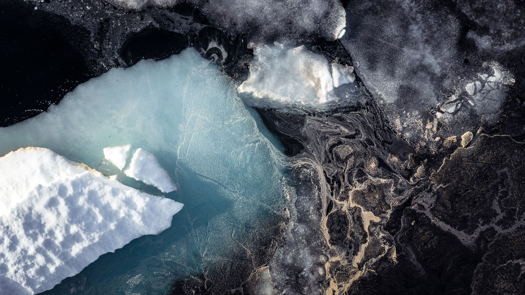 Iceberg and yellow pollen on lake Ståvatn in Norway