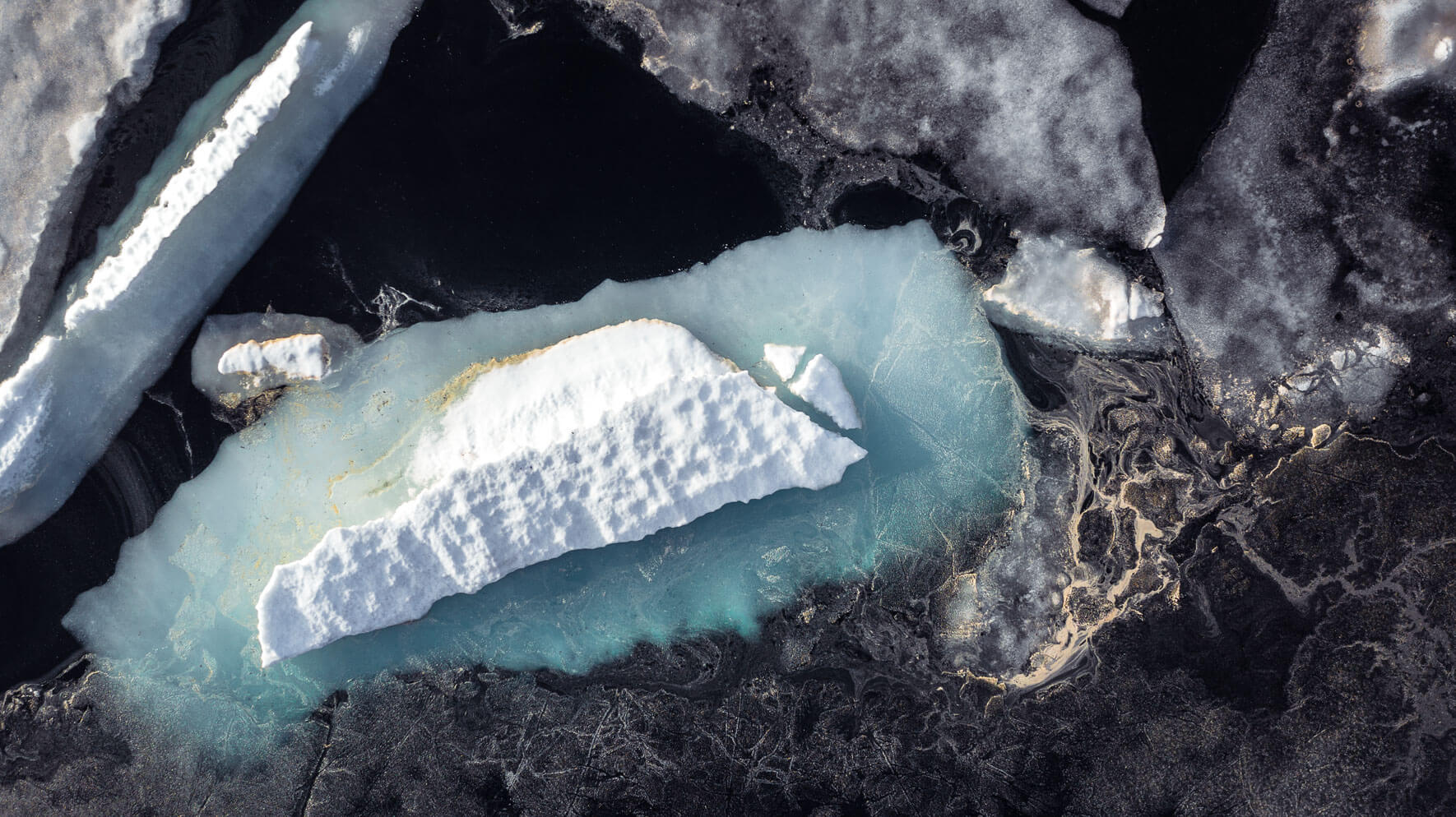Aerial view of icebergs and pollen on a lake in Norway