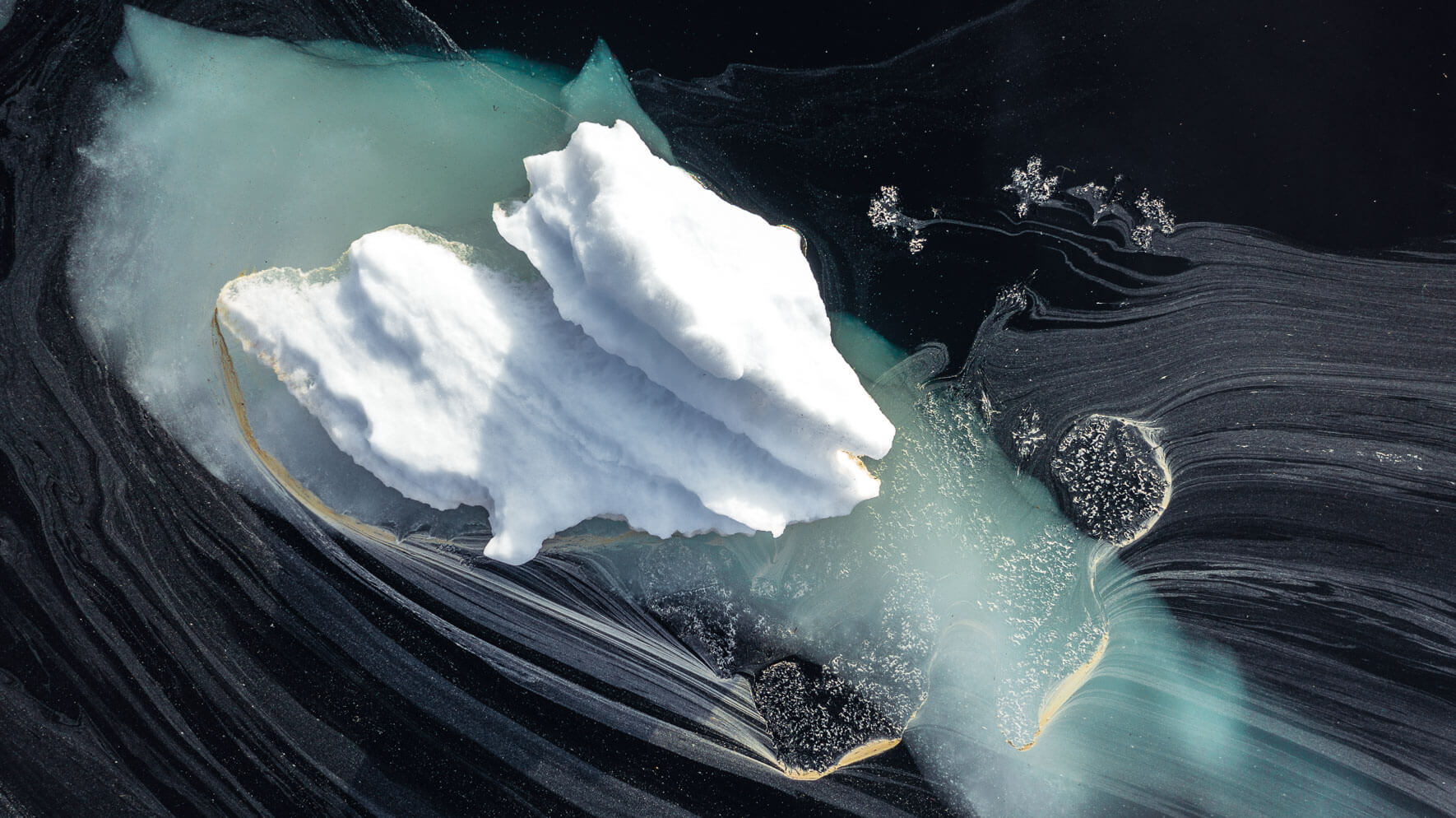 Aerial view of icebergs and pollen on lake Ståvatn in Norway by Jan Erik Waider