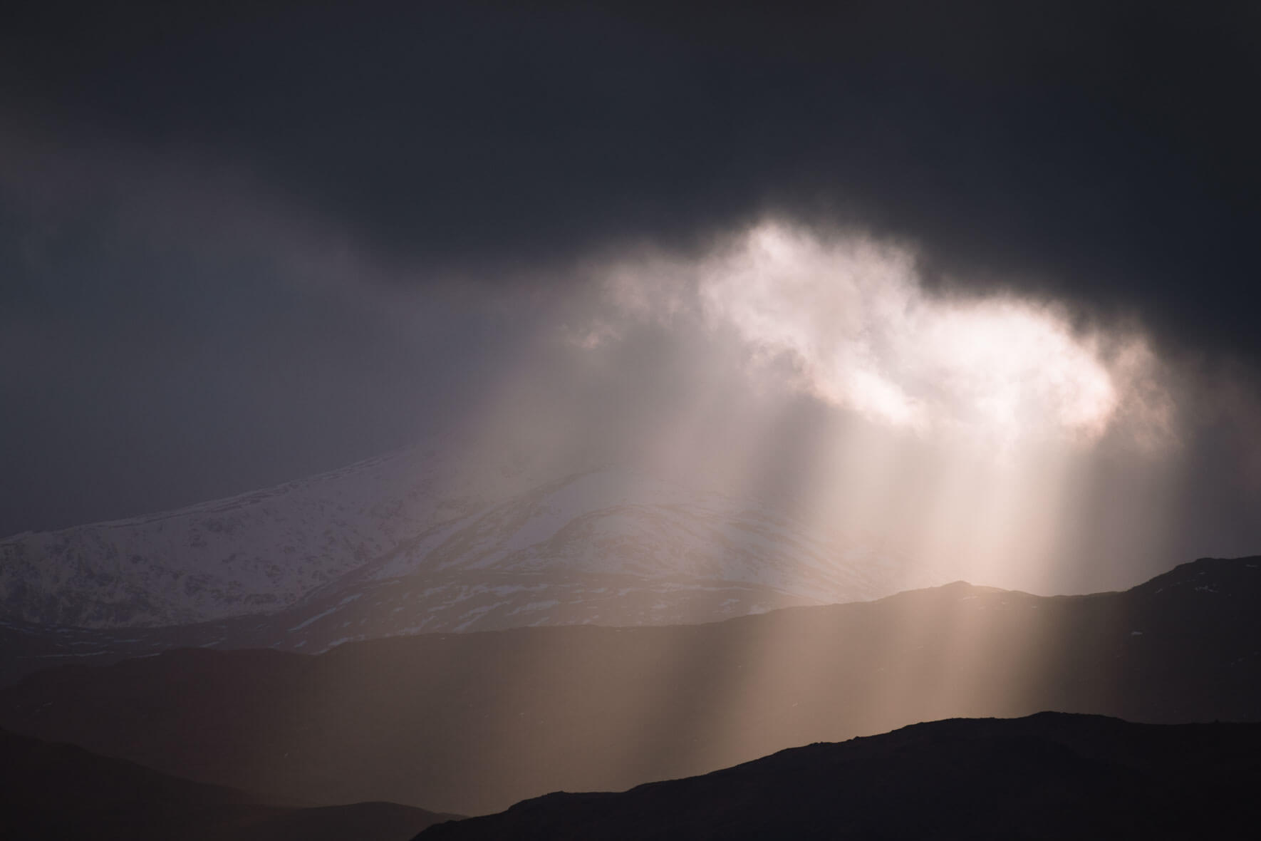 Sun beams over Glencoe in Scotland