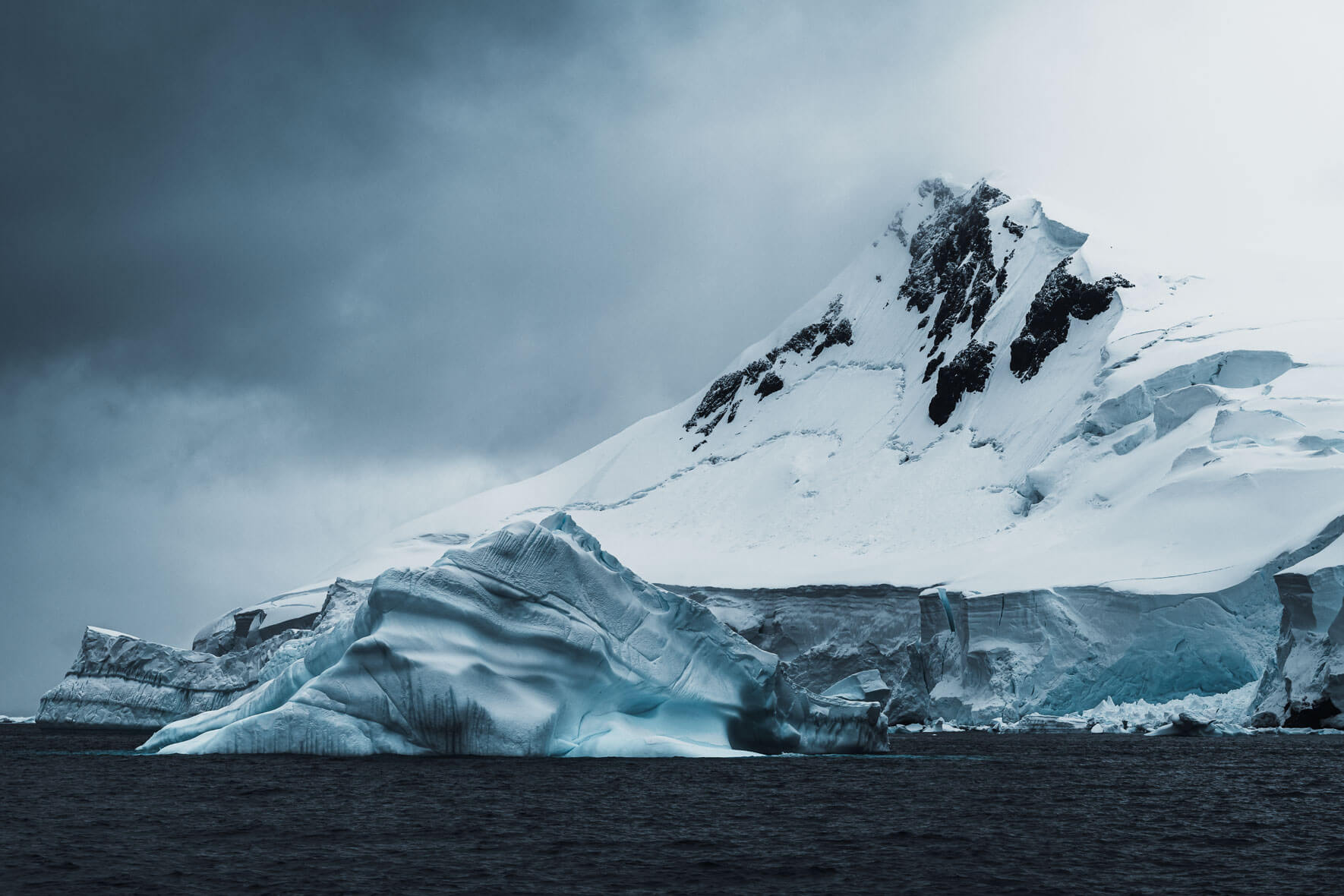 Icebergs with snowy mountains and glacier in the background
