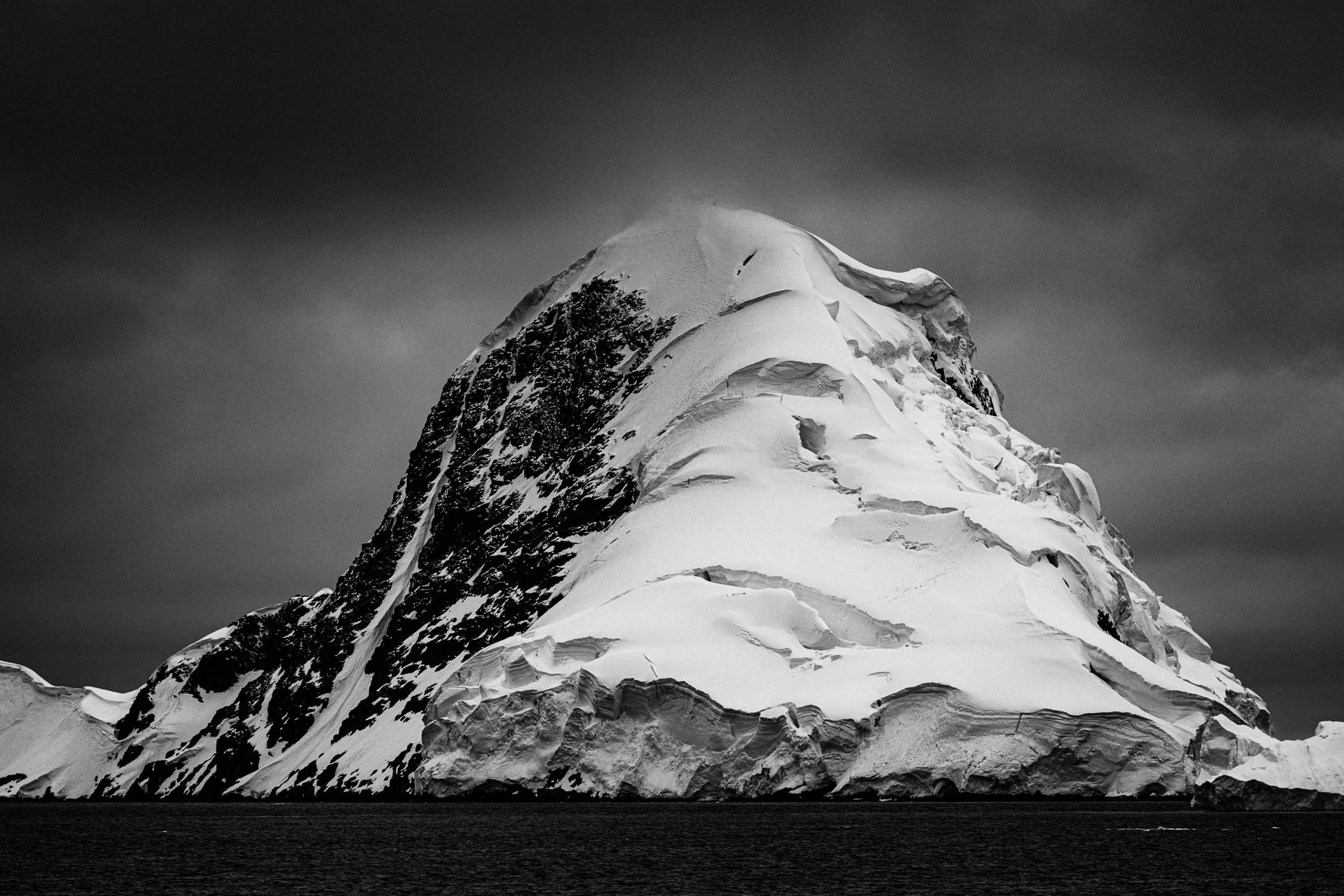 Black and white photo of glacier and mountain in Antarctica