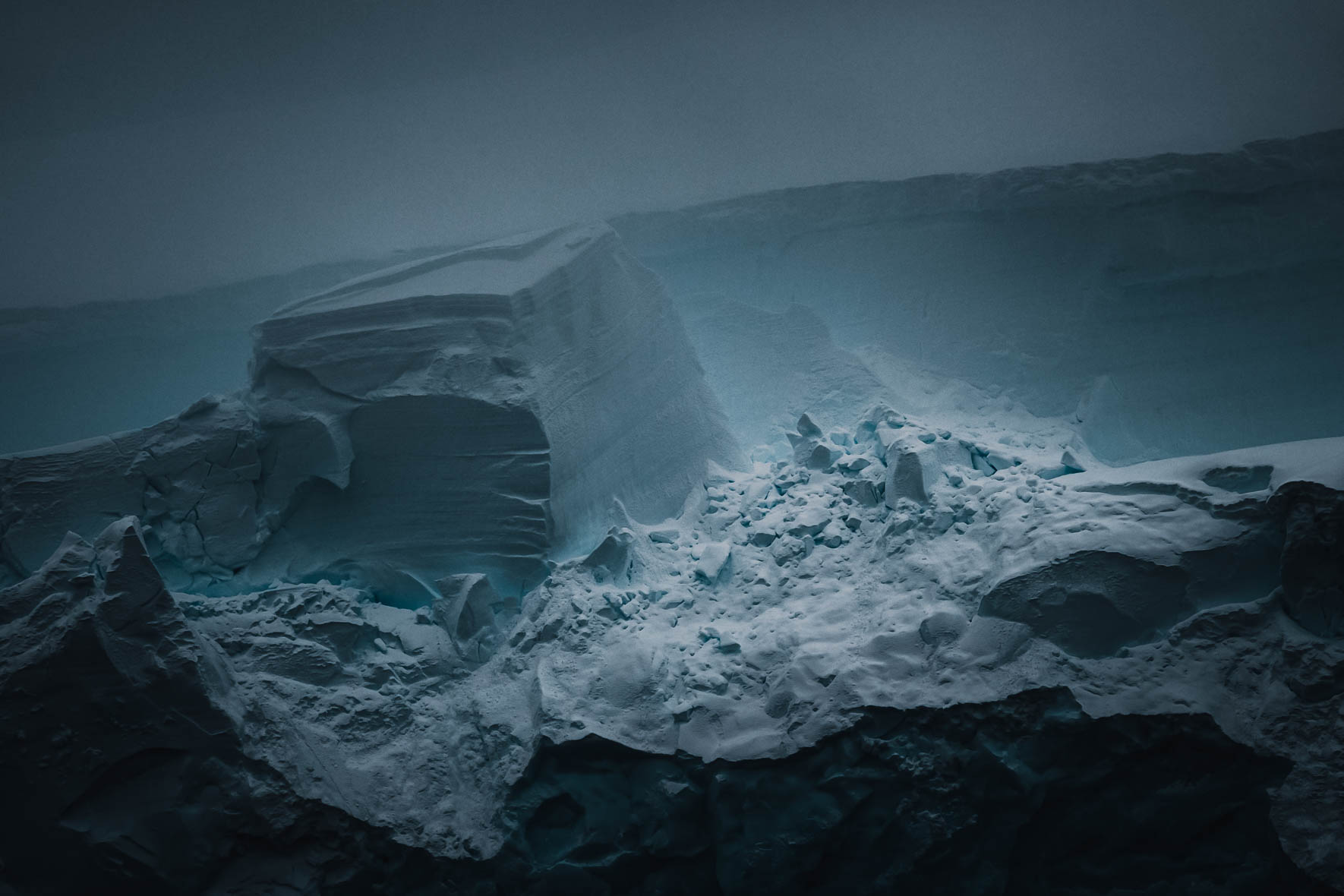 Dark and moody light over a glacier in Antarctica by Northlandscapes