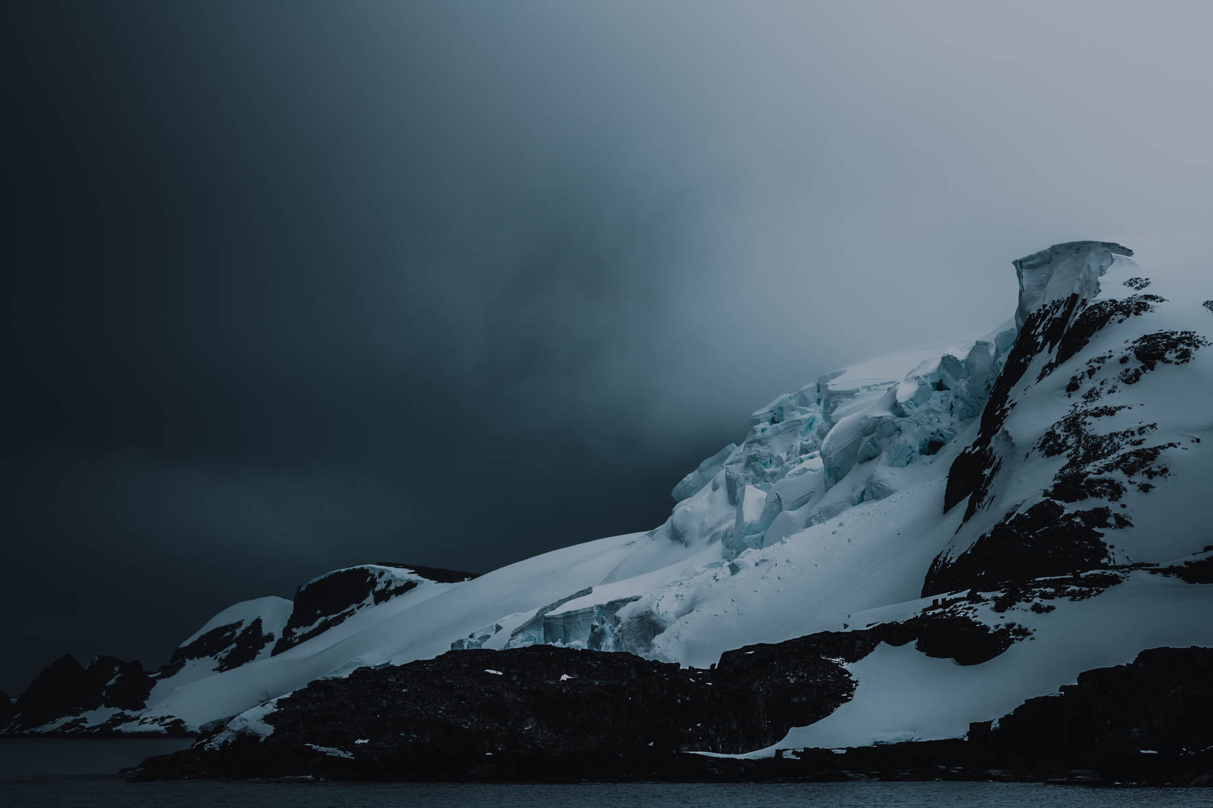 Moody landscape photography of Antarctica with glaciers and mountains