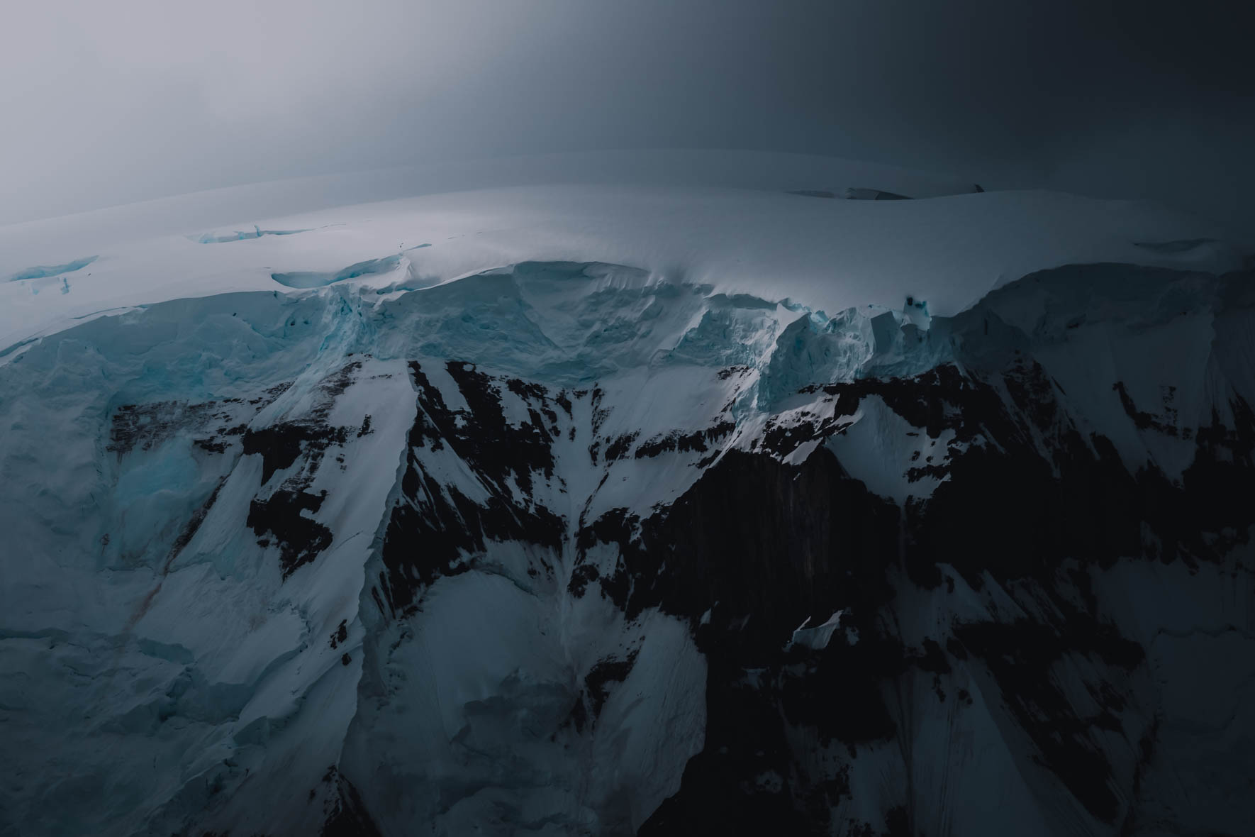 Moody light over a glacial mountain in Antarctica