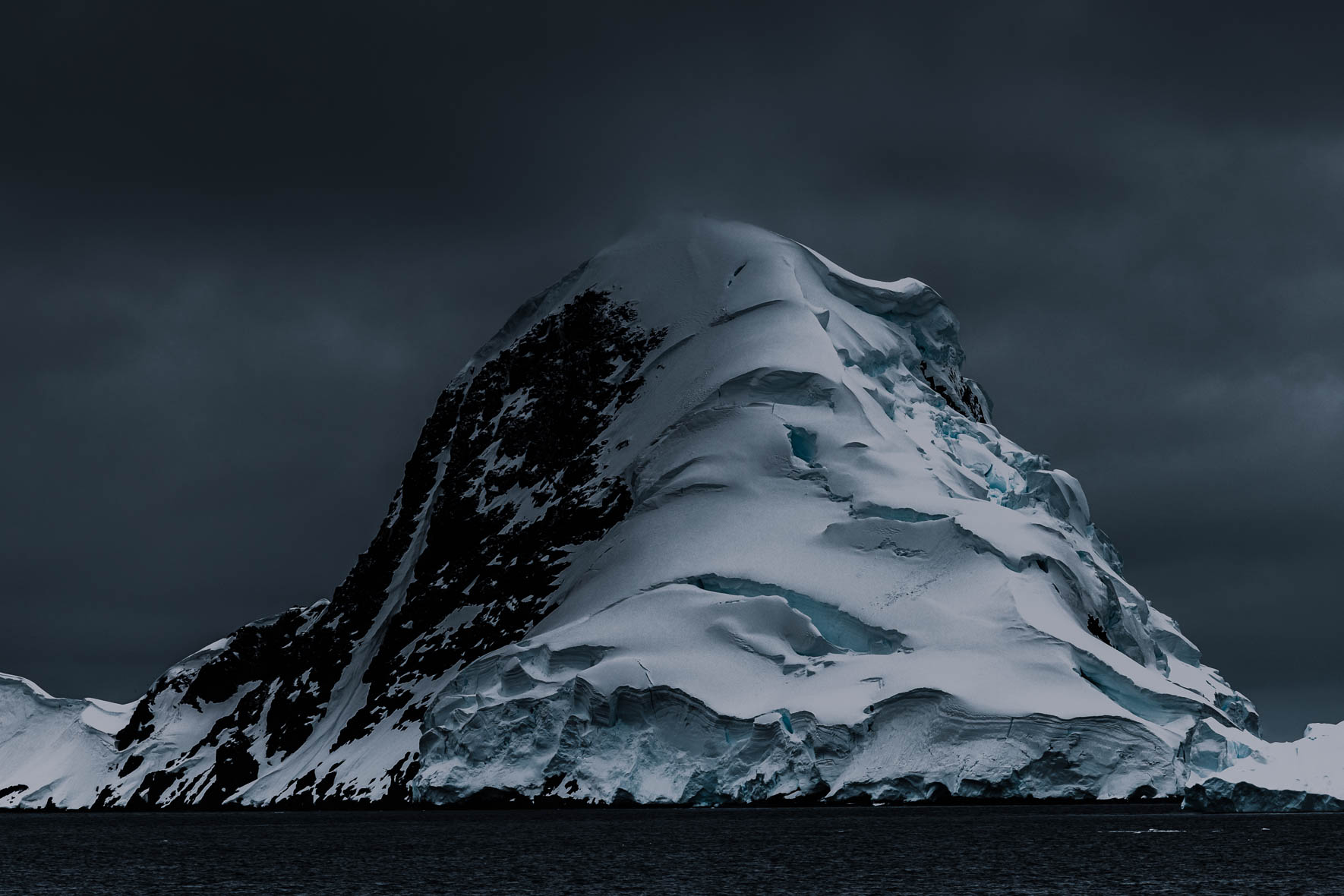 Surreal shaped mountain with snow and glacier ice in Antarctica