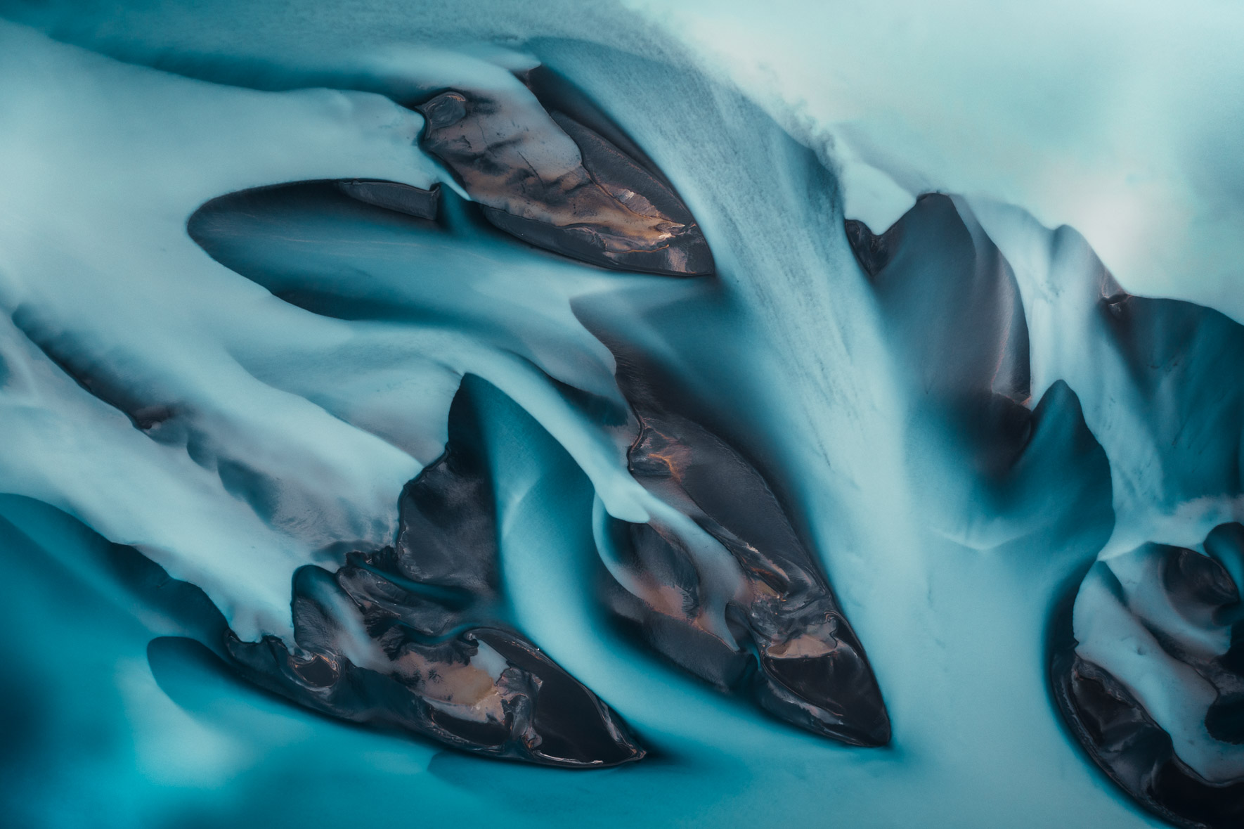 Blue colors of glacier river in Iceland seen from above
