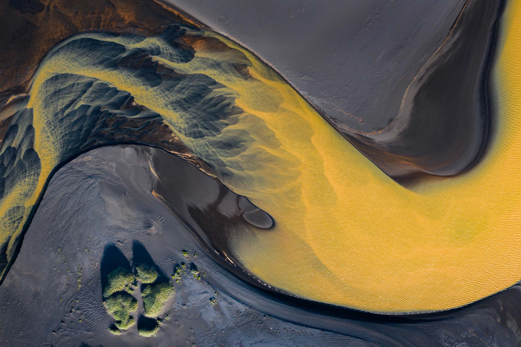 Aerial photograph of colorful glacier river in Iceland with black sand