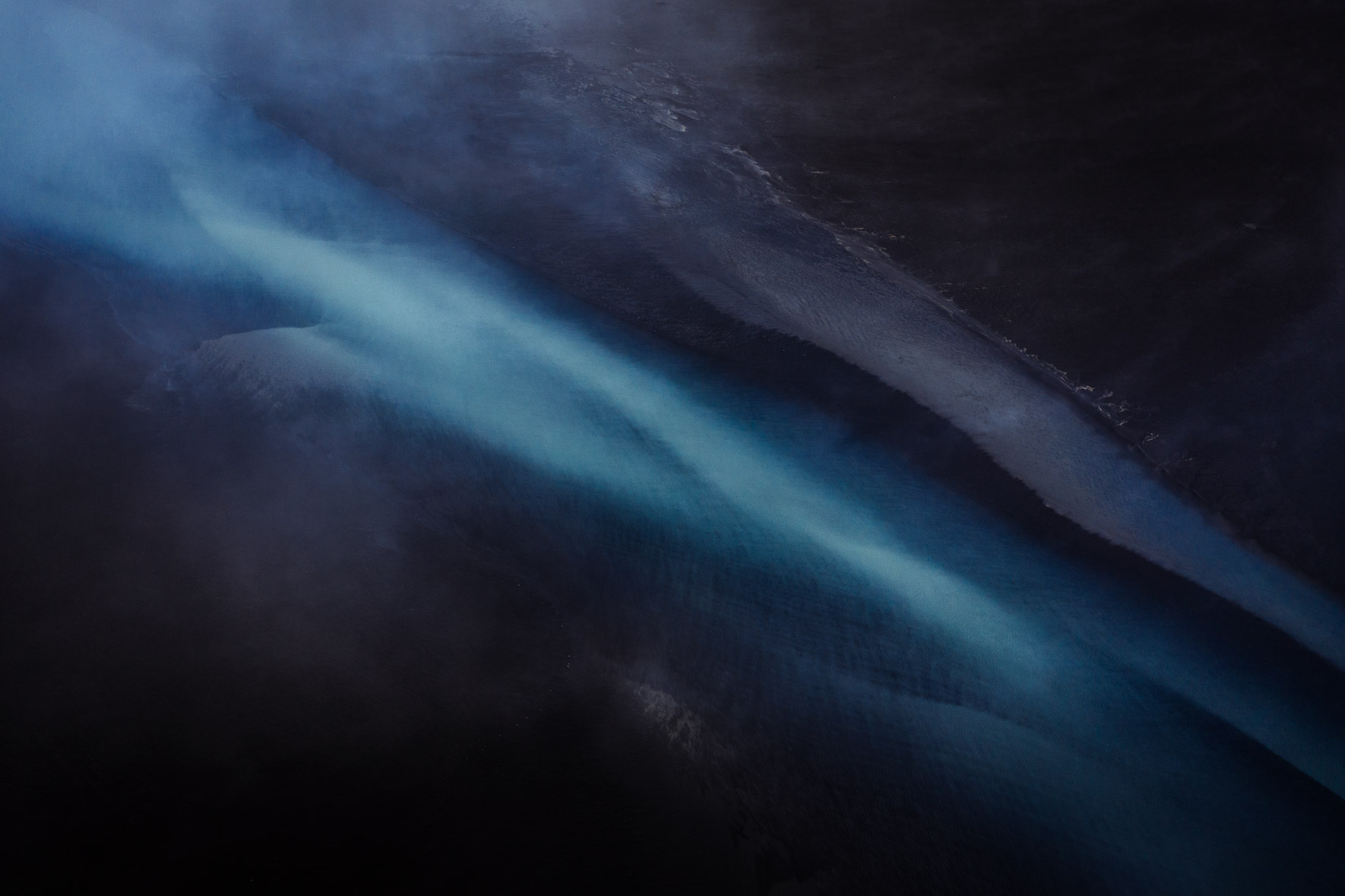 Dark and Abstract Aerial Photography of Glacier River in Iceland
