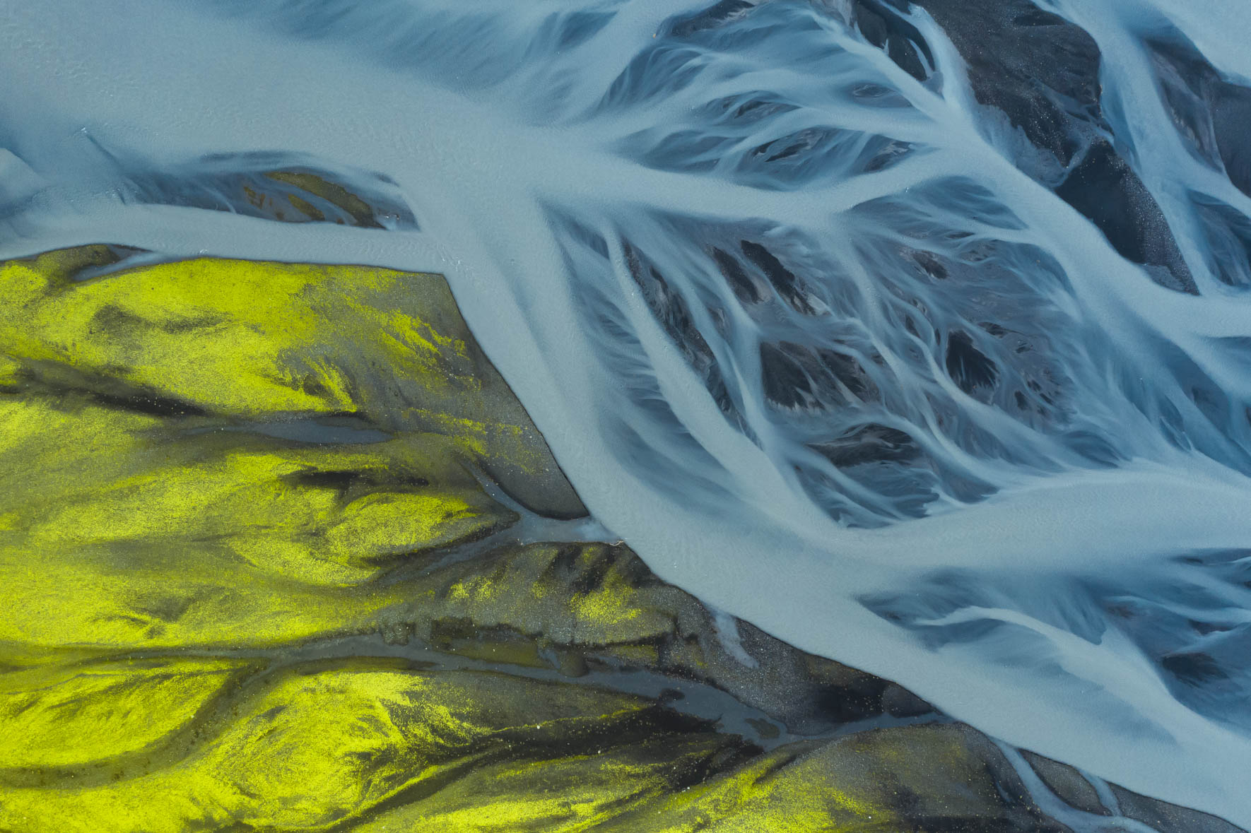 Aerial Photography of Glacier Rivers in Iceland with Neon Green Moss