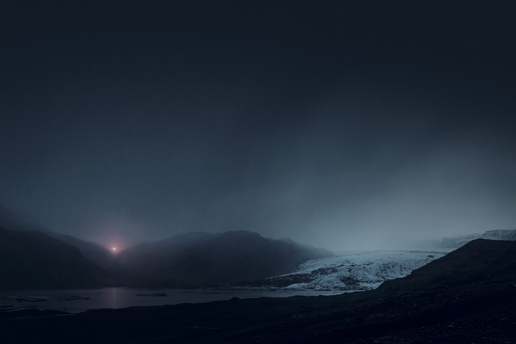 Mysterious light over mountain range with glacier