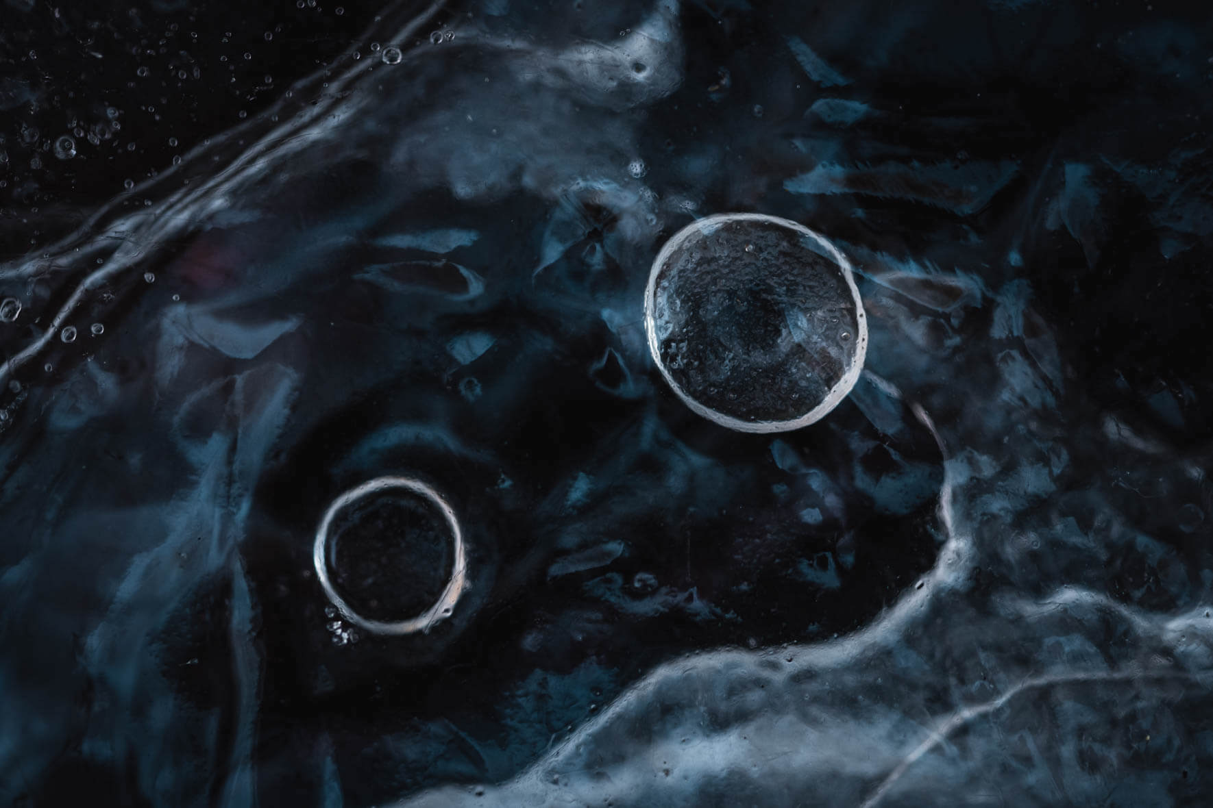 Macro photography of frozen puddle with ice structures and air bubbles