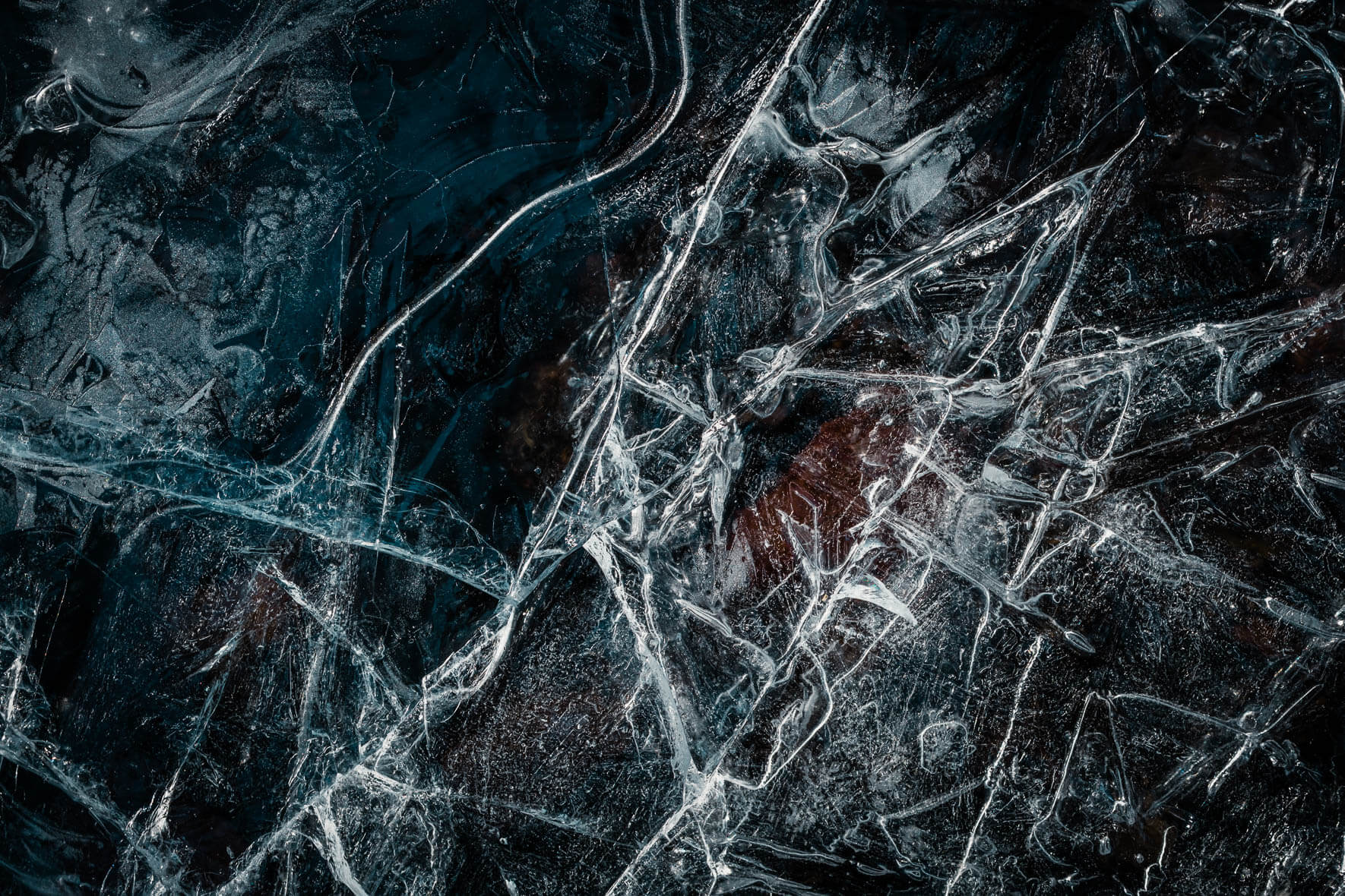 Cracks in the ice of a frozen puddle