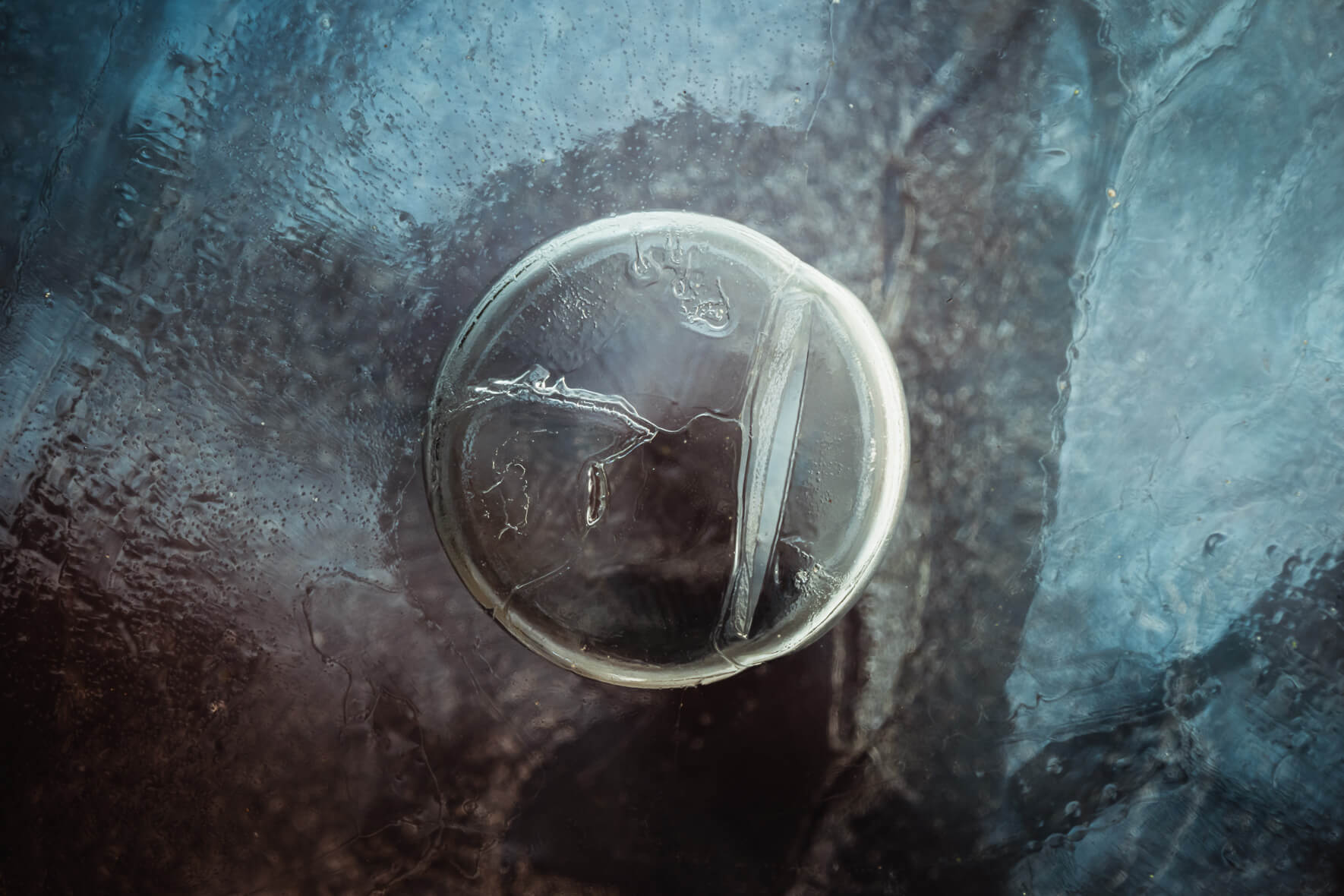 Abstract Macro Photography of Air Bubble in Frozen Puddle