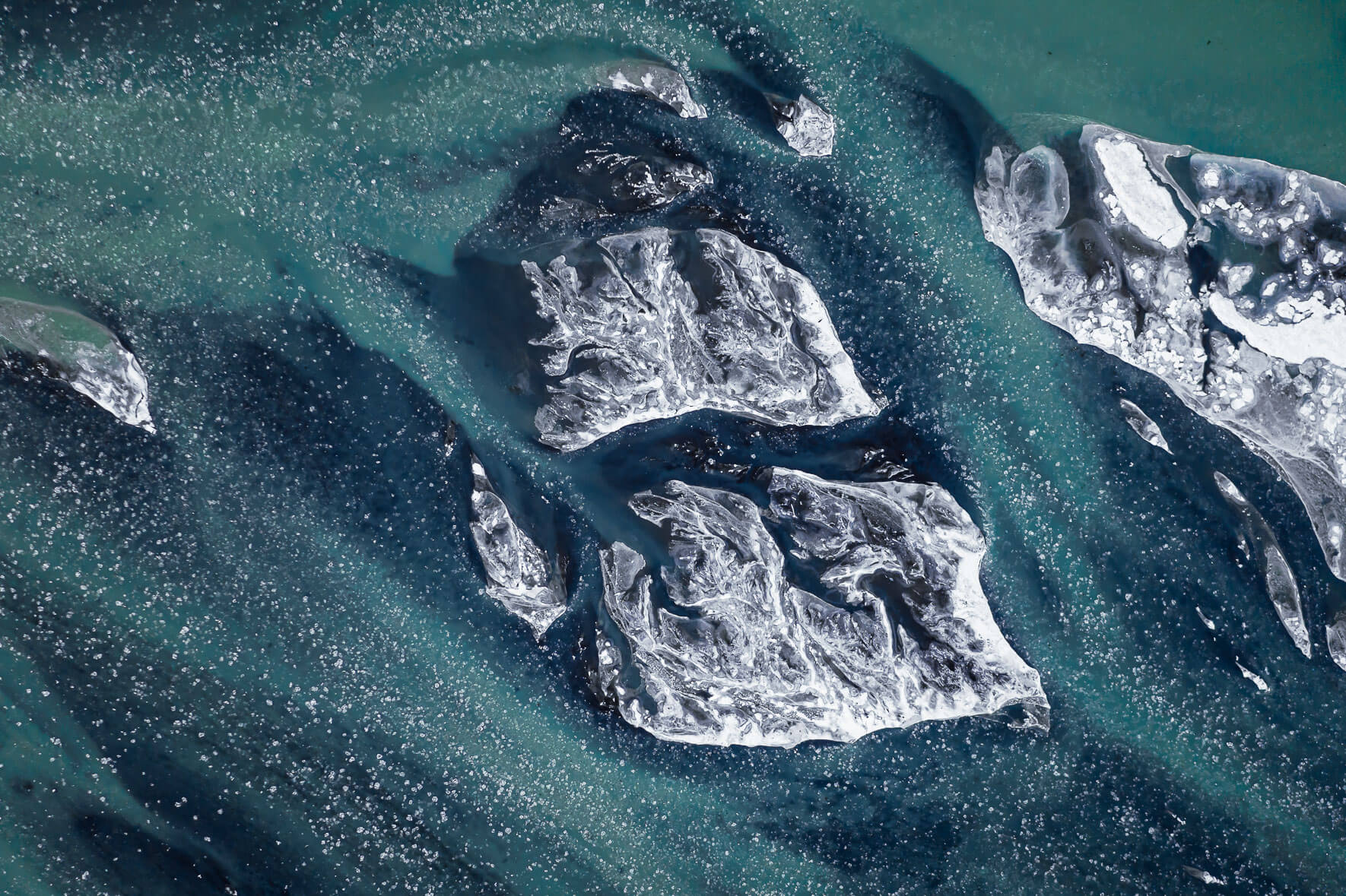 Aerial perspective of river Þjórsá on the south coast of Iceland in winter with small ice floes
