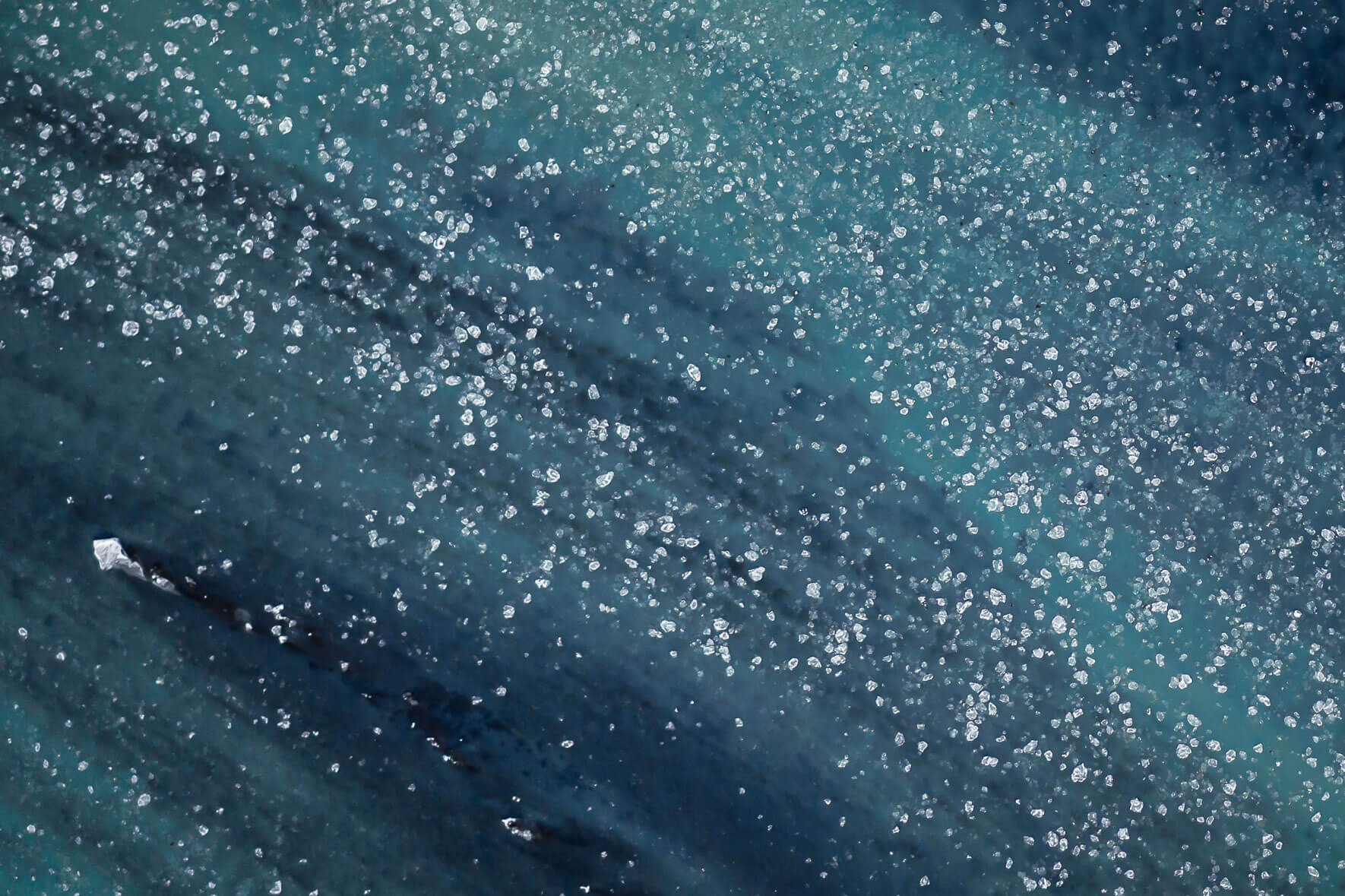 Aerial photgraphy of river Þjórsá on the south coast of Iceland in winter with small ice floes