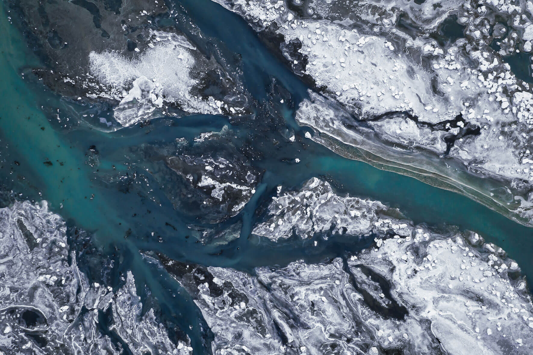 River Þjórsá on the south coast of Iceland in winter with ice floes and frozen over sand island