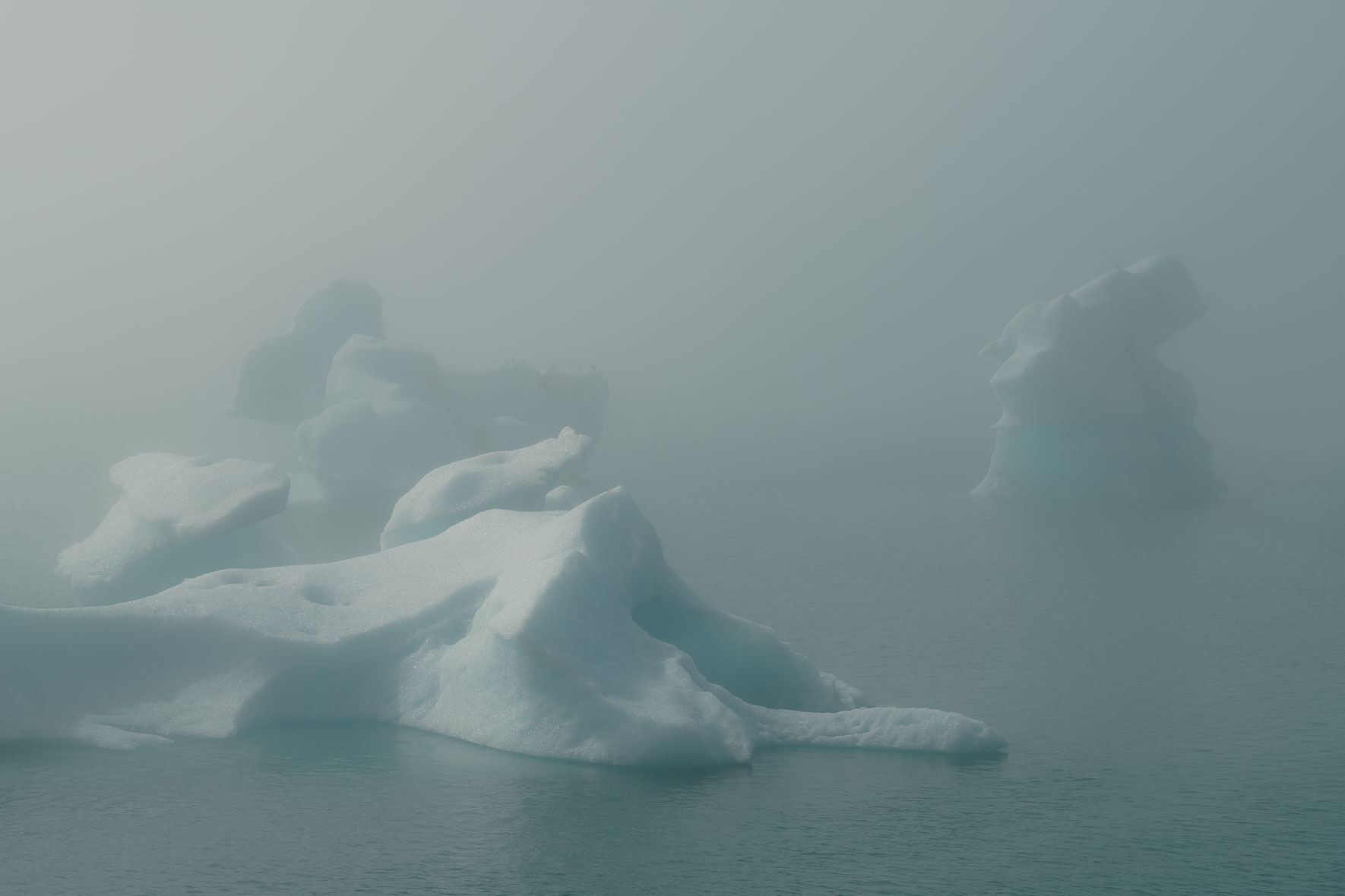 Icebergs in Jökulsárlón glacier lagoon surrounded by fog in summer