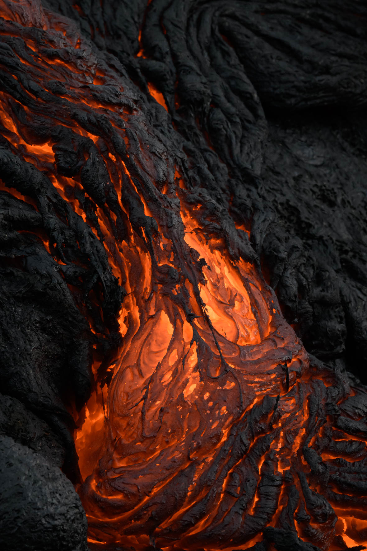 Molten lava flowing from volcanic eruption at Fagradalsfjall in Iceland