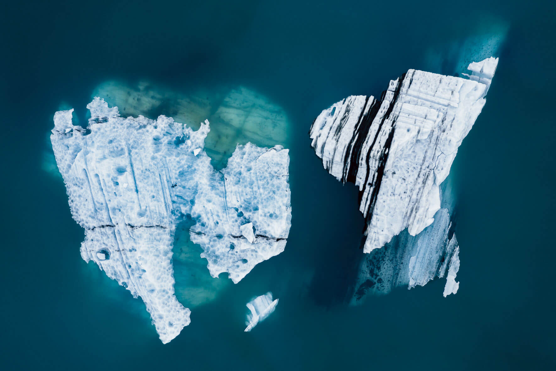 Aerial view of icebergs in turquoise glacier lagoon in Iceland