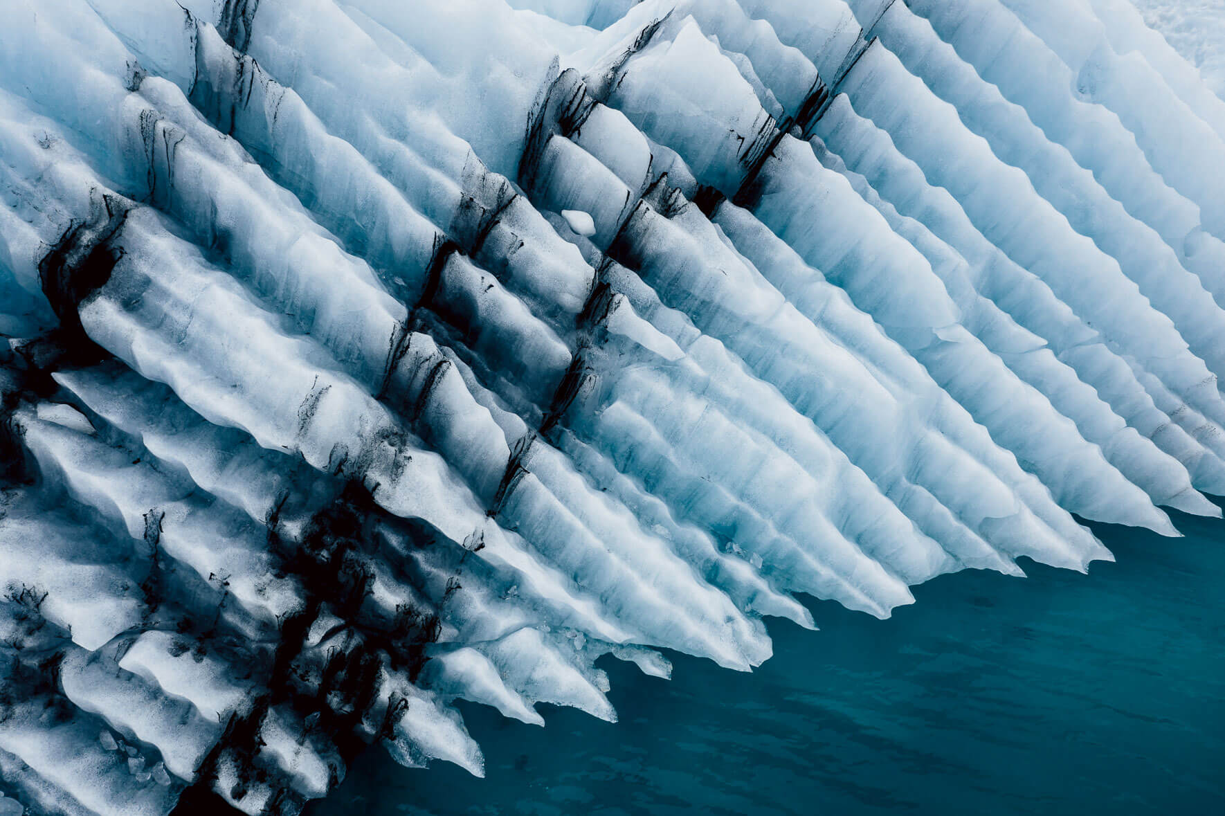 Iceberg with abstract texture and ash in a glacier lagoon in Iceland