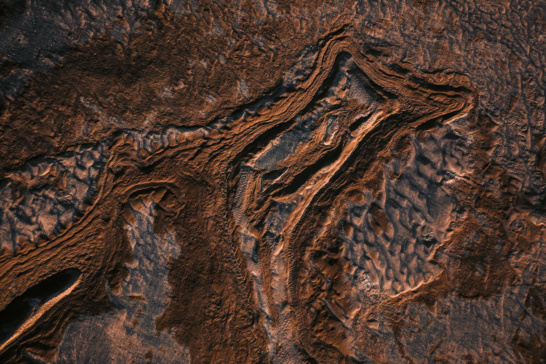 Abstract rock and sand formations from an aerial perspective in the Vatnajökull region in Iceland.