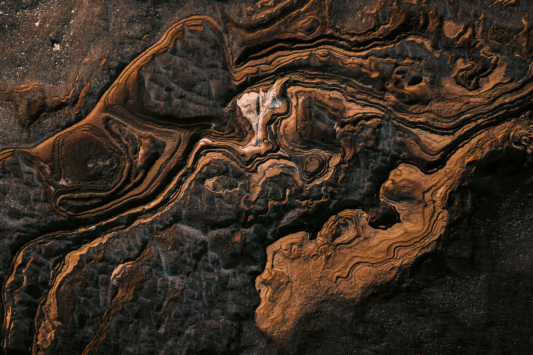 Abstract rock, mud and sand formations from an aerial perspective in Iceland