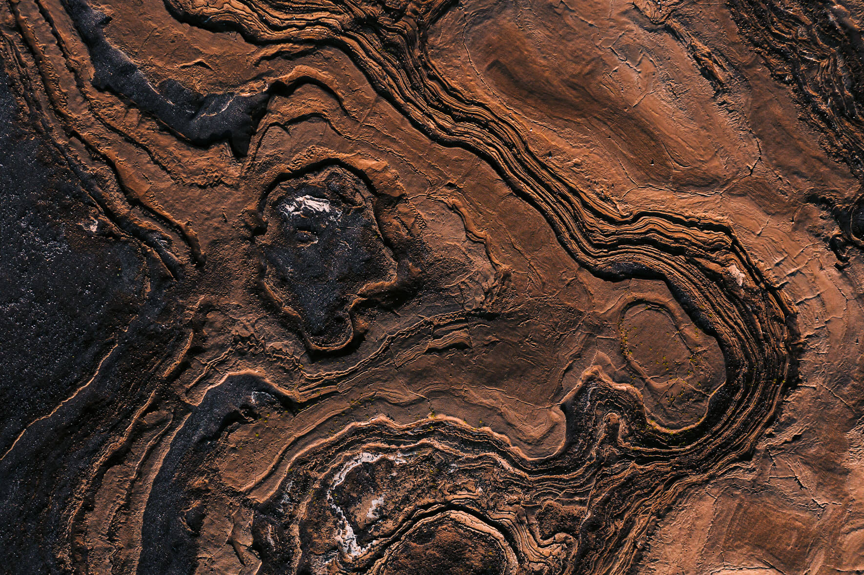 Surreal mud, rock and sand textures from an aerial view in Iceland