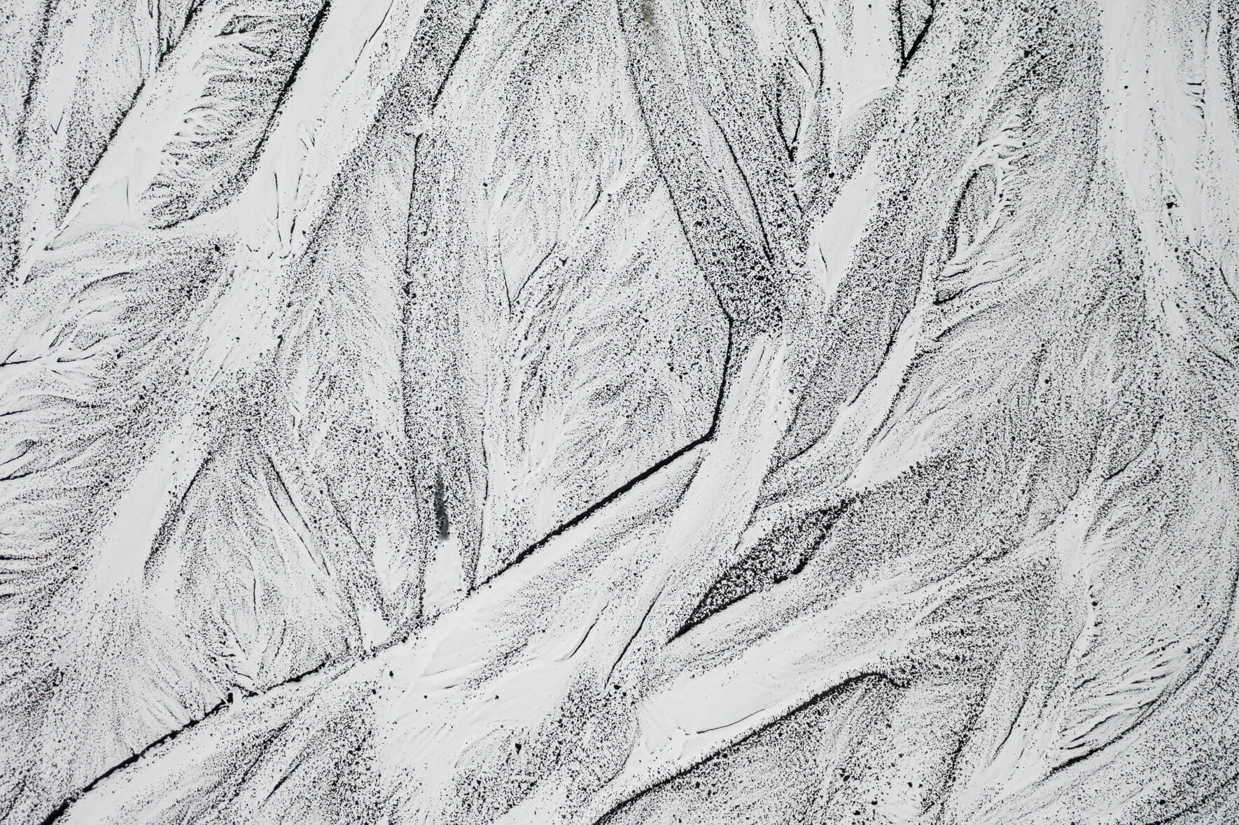 Snow covered sand landscape with dried up river arms