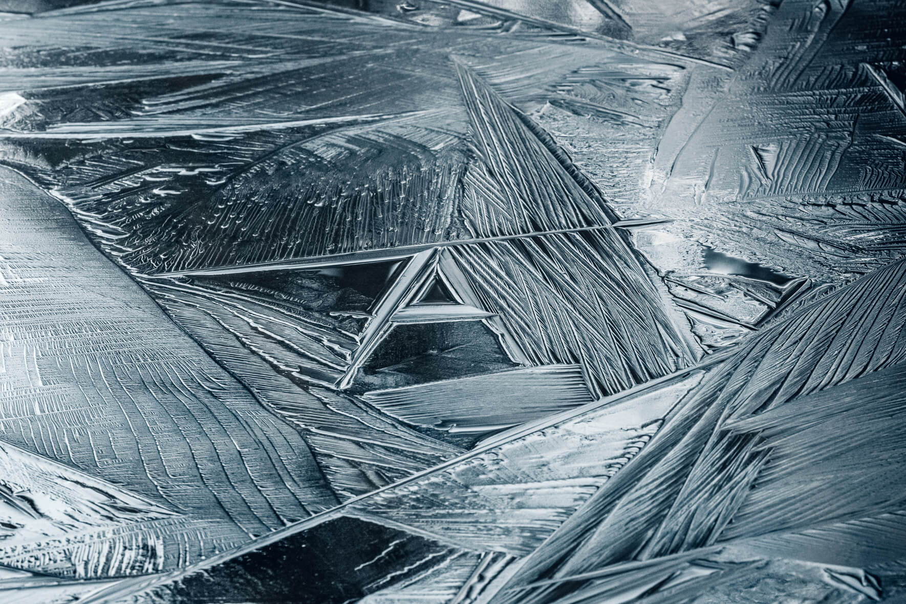 Abstract macro details in the ice surface of a frozen lake at Eibsee in the Bavarian Alps