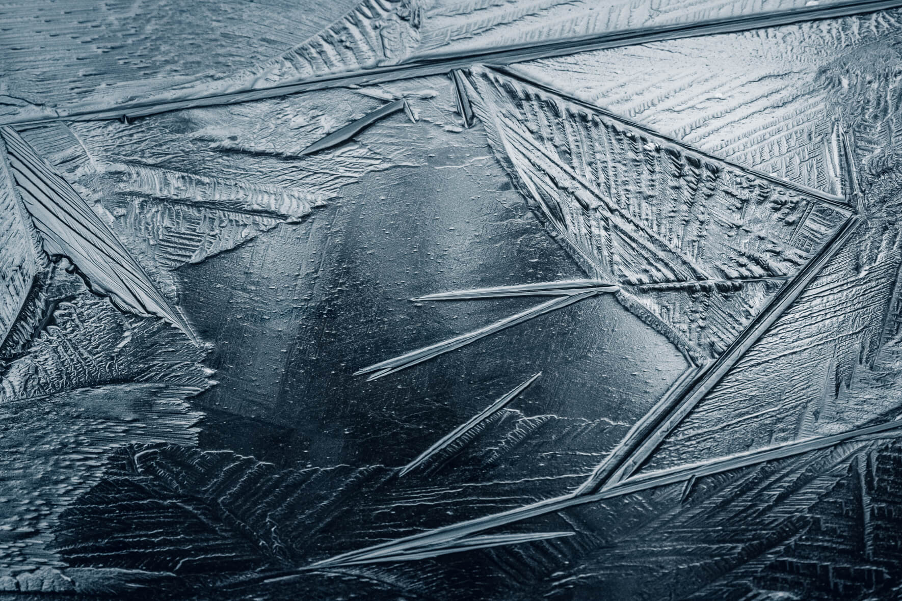 Macro photography details in the ice surface of a frozen pond at lake Eibsee
