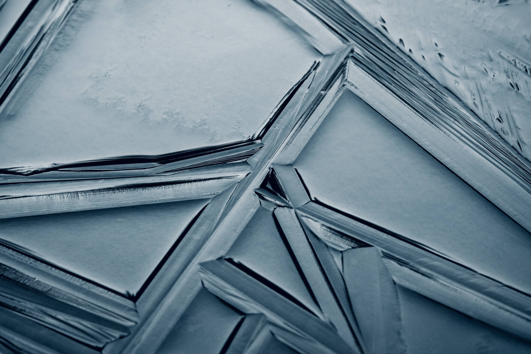 Abstract geometric lines in the surface of a frozen lake in the Bavarian Alps