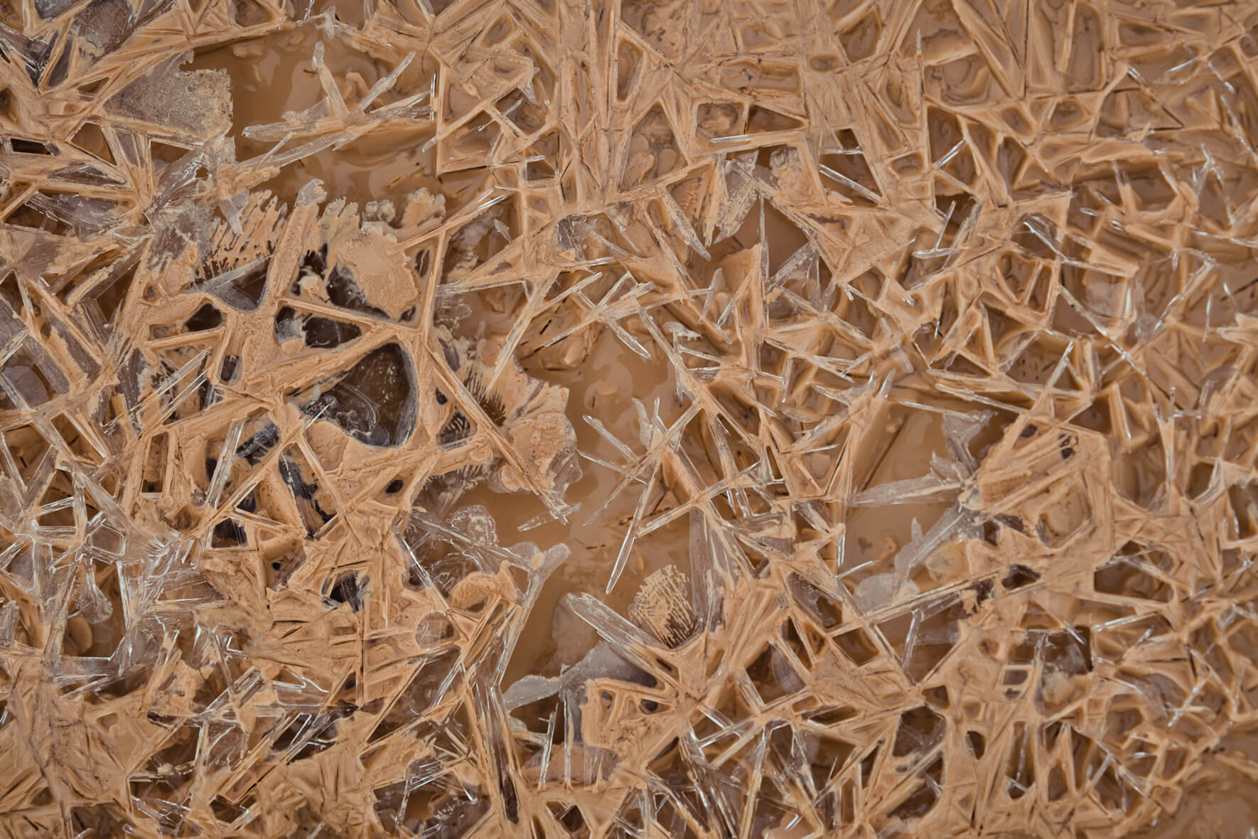 Abstract texture with ice crystals in a frozen puddle