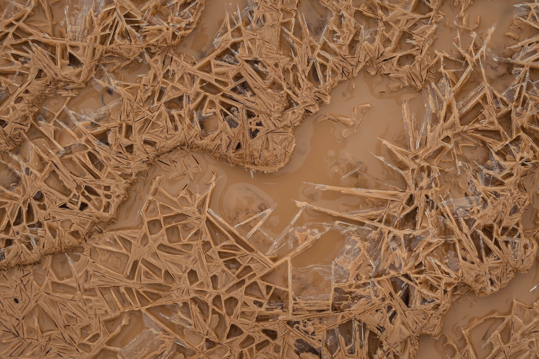 Macro photography of ice crystals in a creek at Námafjall geothermal area in Iceland