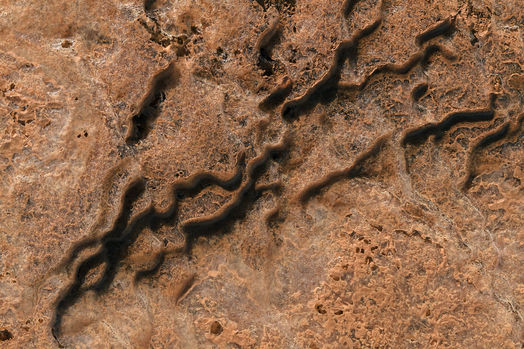 Abstract ice crystals in a frozen puddle in the Námafjall geothermal area near lake Mvyatn
