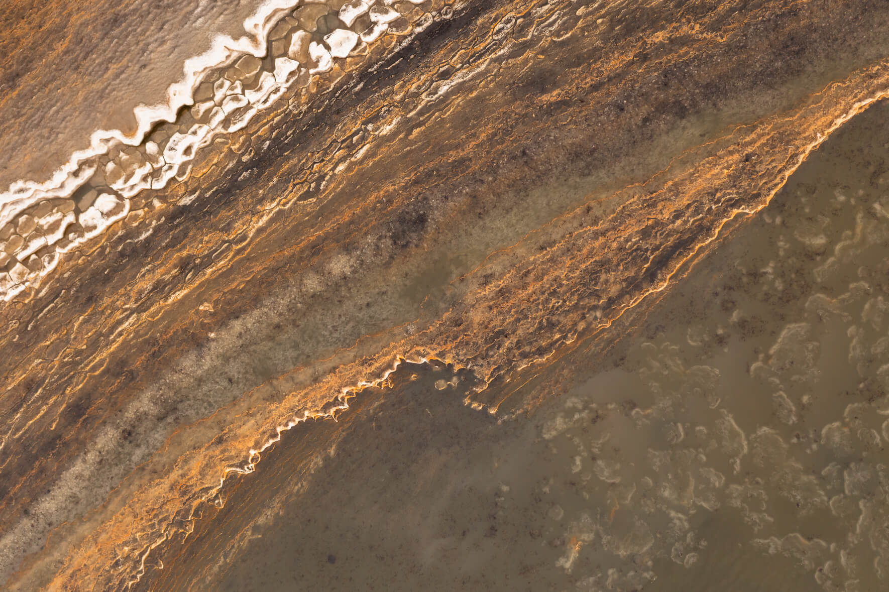 Abstract and colorful texture of frozen ponds on Jökuldalsheiði plateau in eastern Iceland