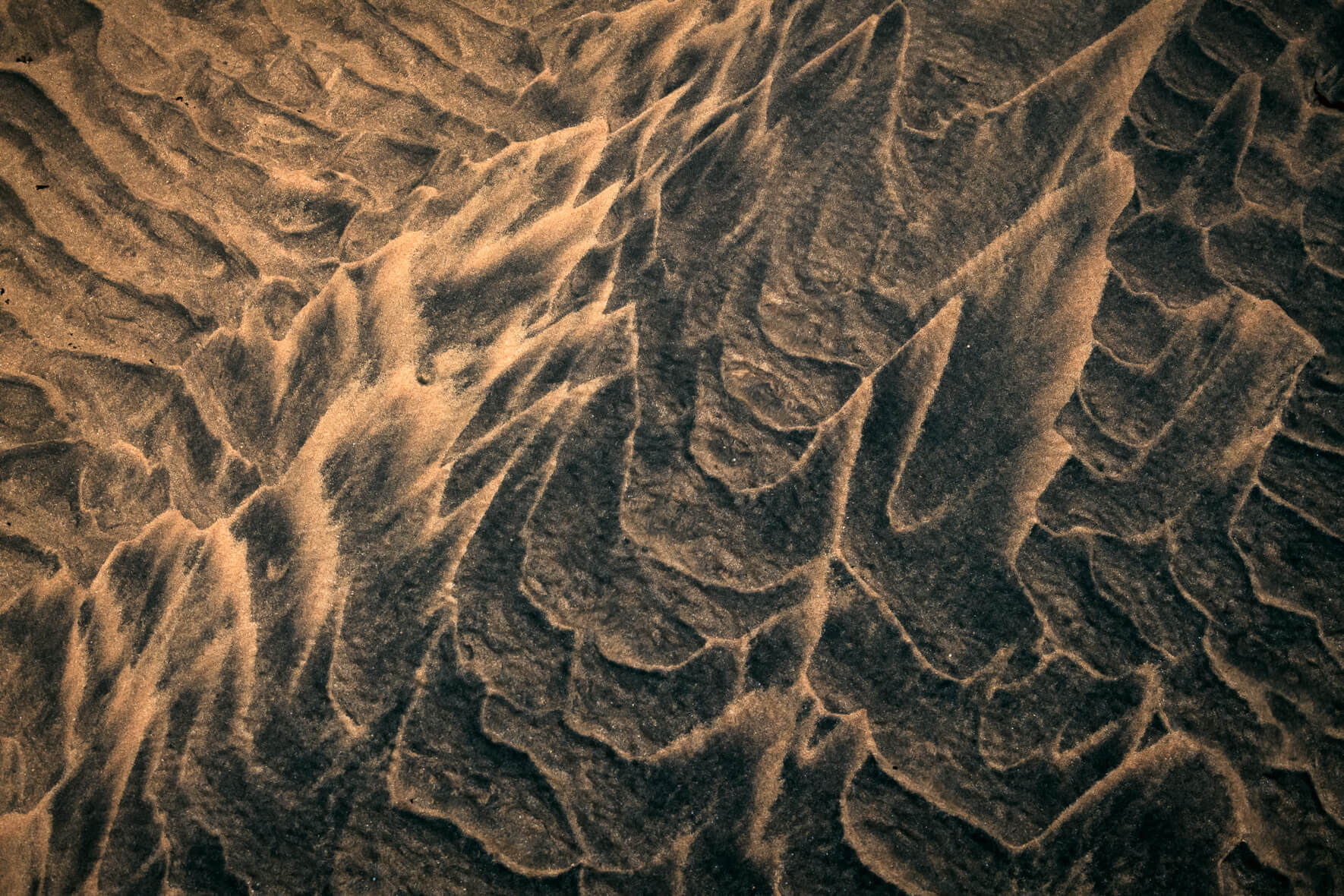 Sand formed by sea water on a beach in the Westfjords of Iceland