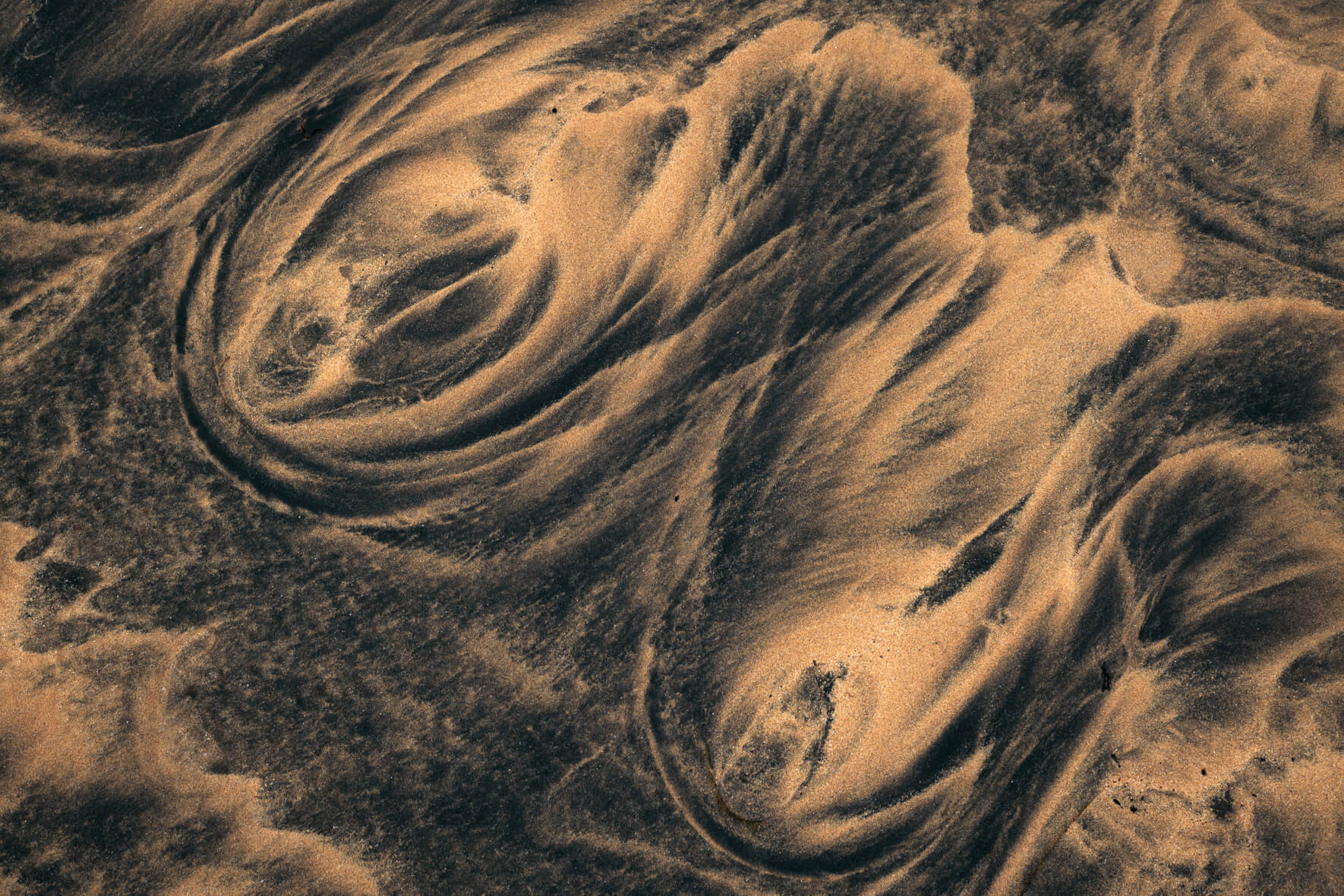 Wave like textures in the sand of a beach in the Westfjords of Iceland