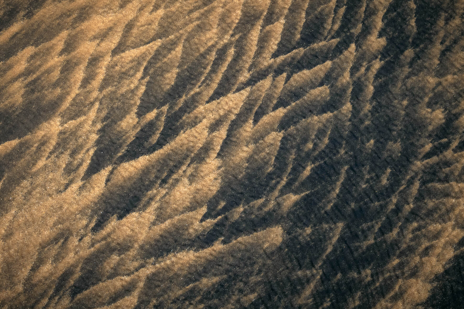 Wave like textures in the sand of a beach in the Westfjords of Iceland