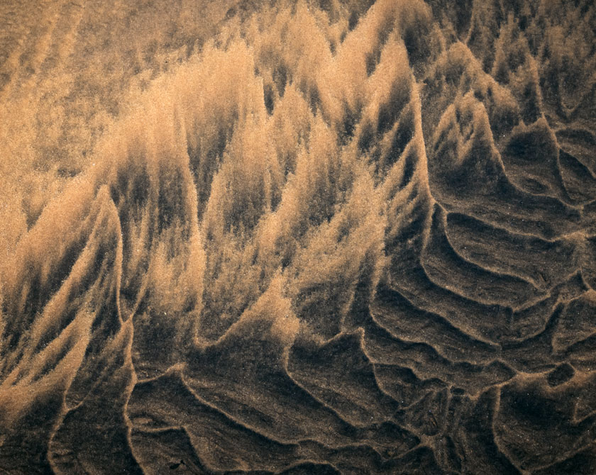 Wave like textures in the sand of a beach in the Westfjords of Iceland