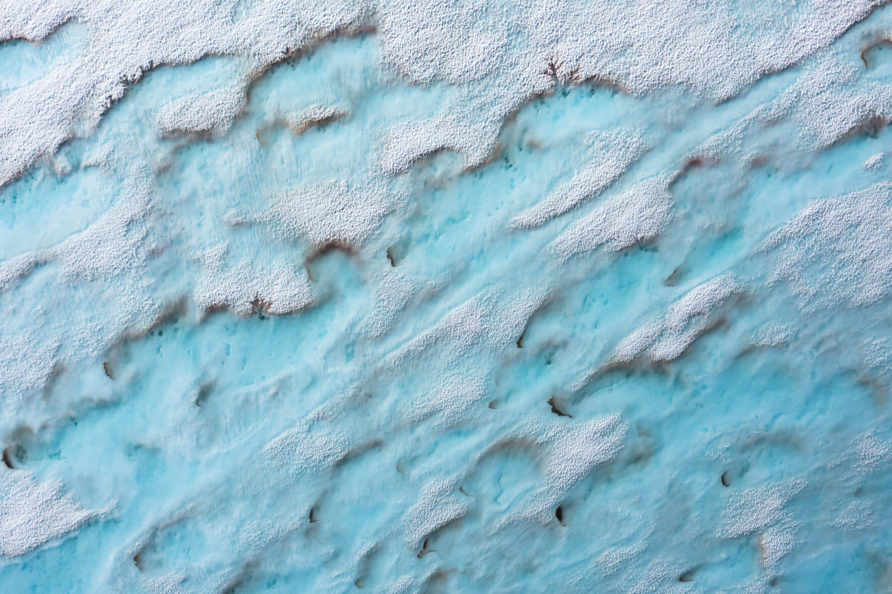Meltwater lakes on a frozen lake in the mountains of Southern Norway in early summer