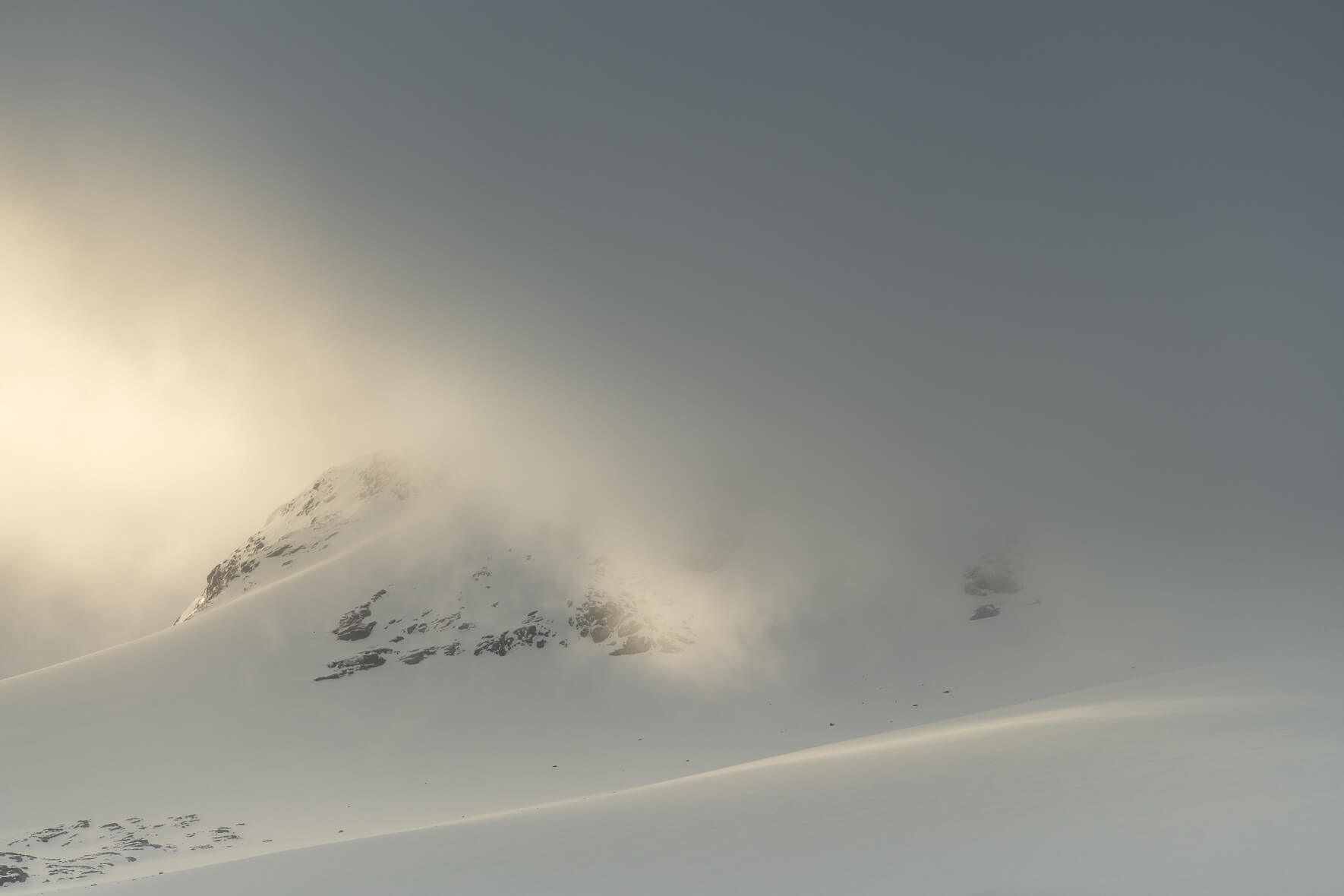 Sognefjellet mountains dramatic winter light and dark clouds over the snow-covered peaks