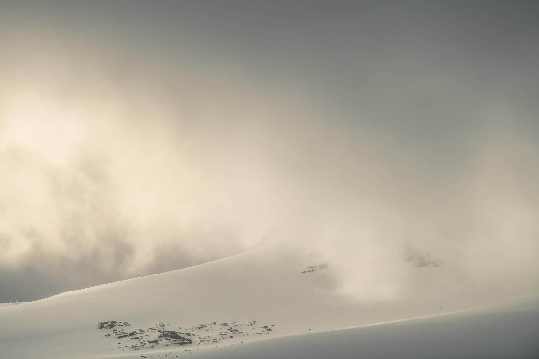 Sun breaks through the clouds over the Sognefjellet mountains in Norway