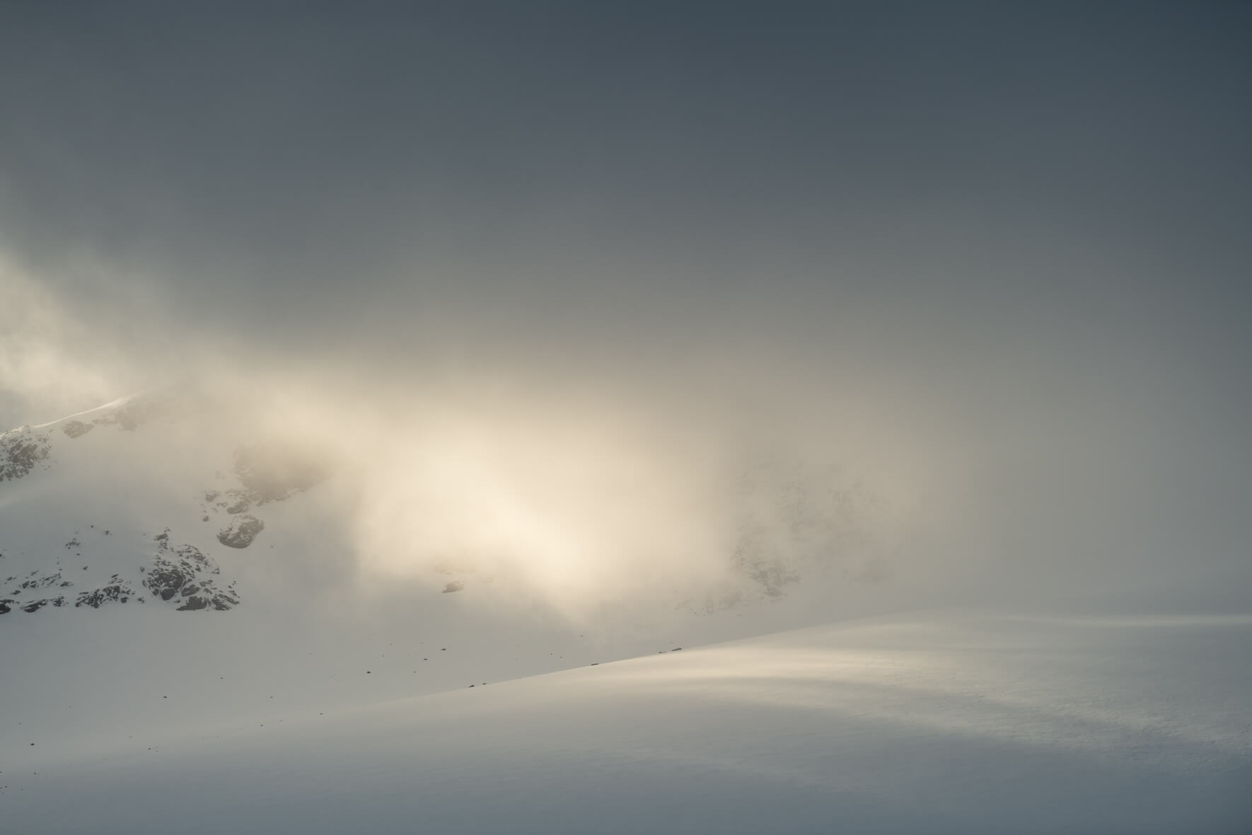 Dramatic landscape with clouds over the Sognefjellet mountains and the sun breaking through