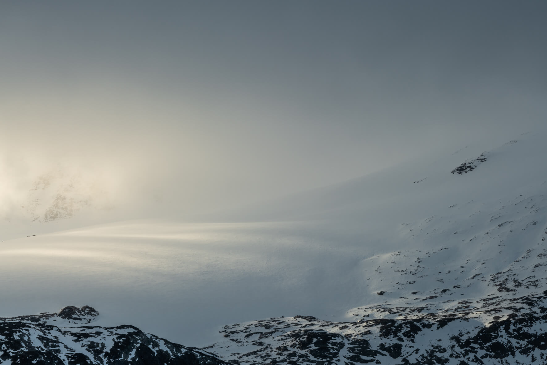 Sun breaks through the dark clouds over the Sognefjellet mountains in Norway