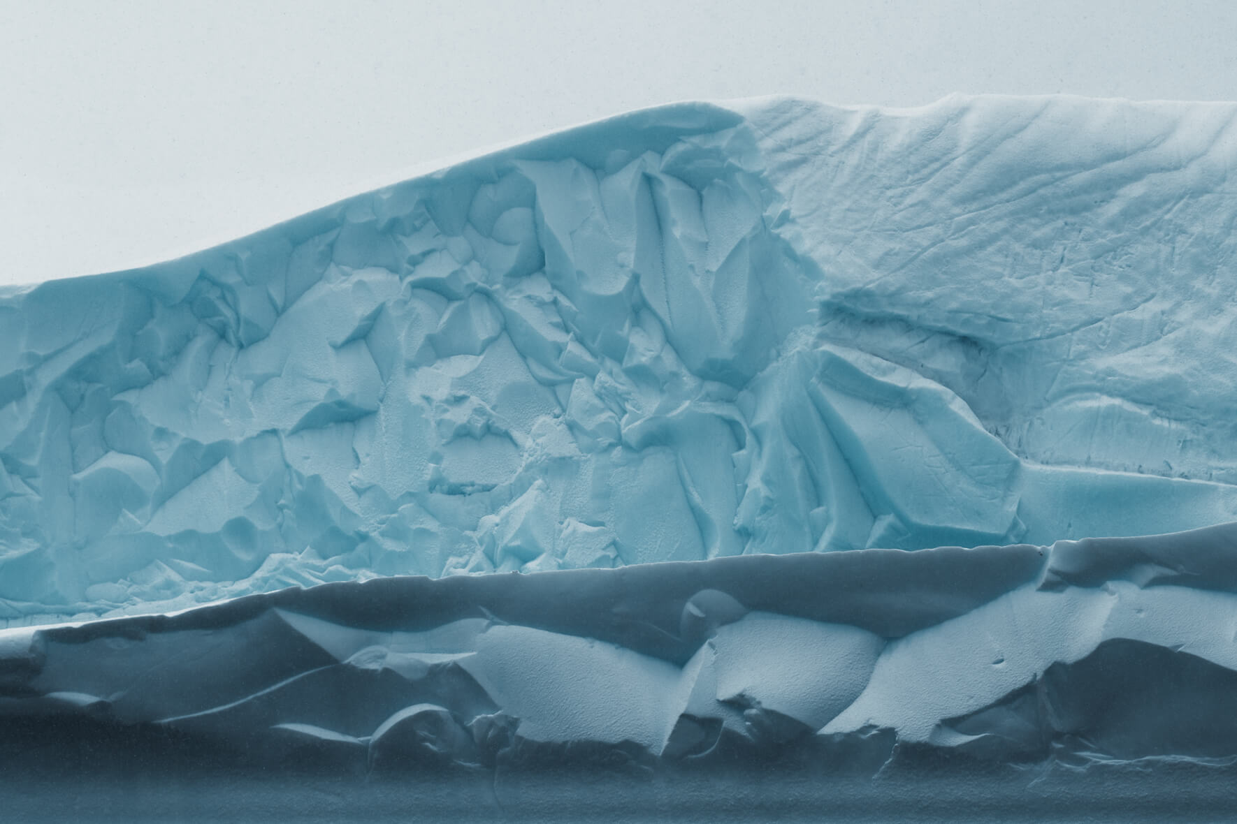 Abstract and almost paper-like textures of an iceberg in Antarctica
